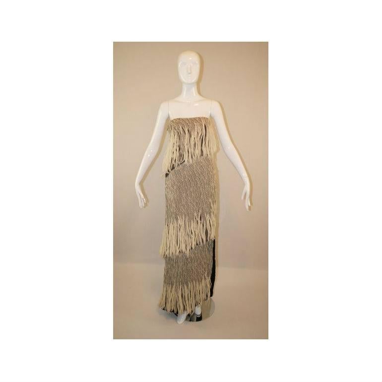 DESIGNER: 1990's Jacques Fath by Tom Van Linden

Please contact for more information and/or photos.

CONDITION: GREAT- THE DRESS IS MEANT TO BE DISTRESSED- THERE IS A SMALL AREA OF FRINGE IN THE BACK WHERE IT IS SLIGHTLY DARKER (PLEASE SEE LAST