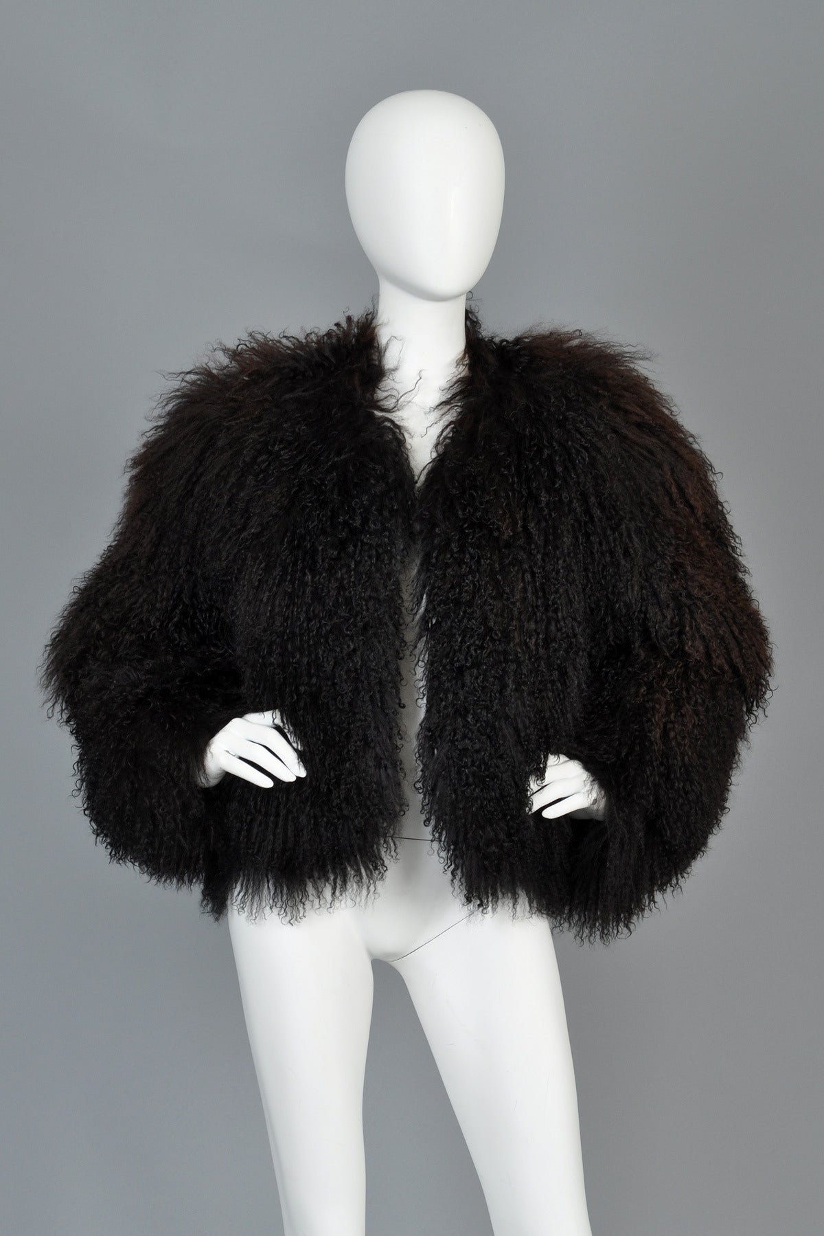 Killer vintage 1980s black cropped mongolian lamb coat. EVERYONE needs one of these in their wardrobe and I think I get more requests for these cropped black mongolians than any other fur. Simple and classic black mongolian lamb. Nice high,