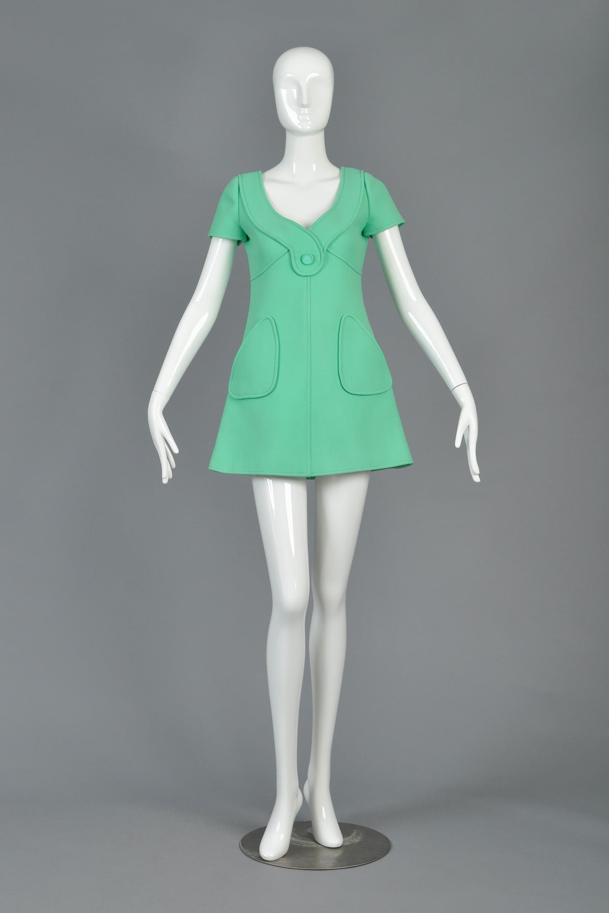 Unbelievable vintage couture mini dress from Andre Courrèges, c. 1964-66. Swooping neckline + plunging back with button tab. Oversize geometric pockets. Topstitched details. Metal zipper in back. Truly a work of art + all the hallmarks of iconic