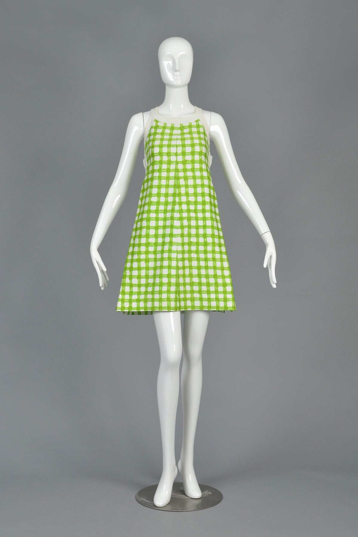Amazing vintage 1960s/70s mod dress by Andre Courrèges. Fantastic painterly green + white plaid (a Courrèges staple since the label's inception). White trim + straps. Snap closure up both sides. Adjustable criss-cross straps in back. Fully labeled.