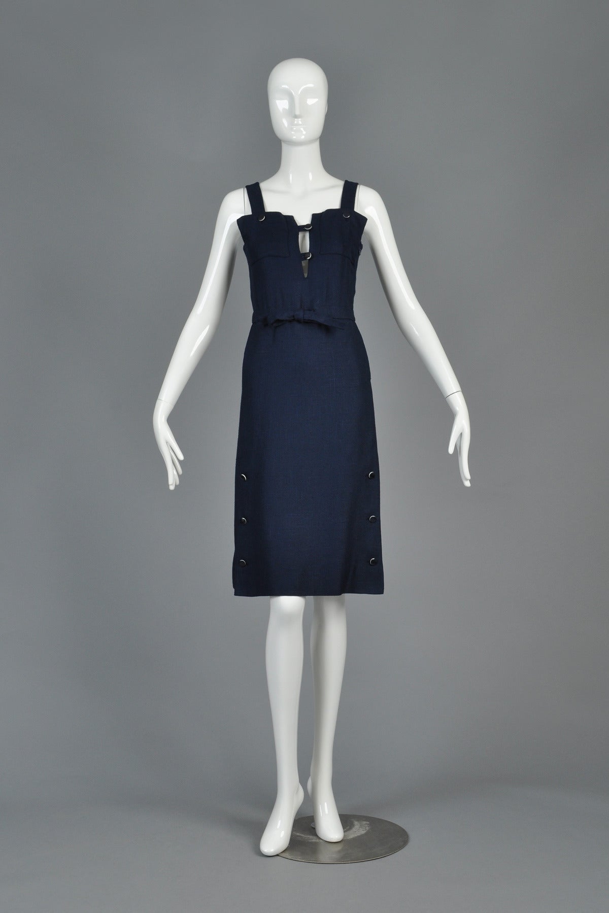 Insanely cute vintage 60s/1970s dress by Andre Courrèges. So many great details! Navy snaps with white edging at hem + bust. “Overall/jumper construction with big square pockets at bust. Loop button closures at plunging, notched neckline. Faux