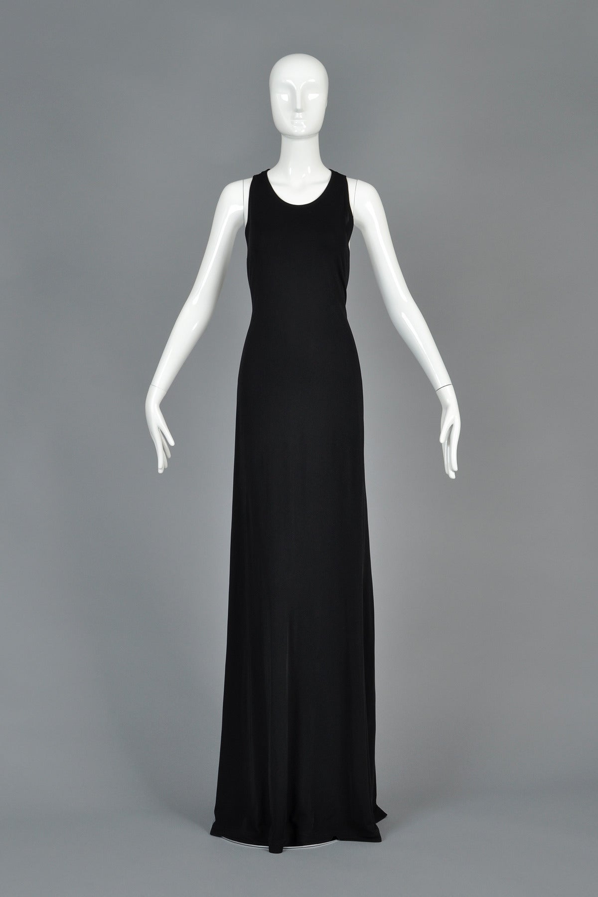 Absolutely beautiful Calvin Klein Collection black evening gown. The ultimate in slinky black dresses! Dress features high neckline with deep cutting underarms (nearly to the waist!) and huge slits up each side in the back. Ultra long, supermodel