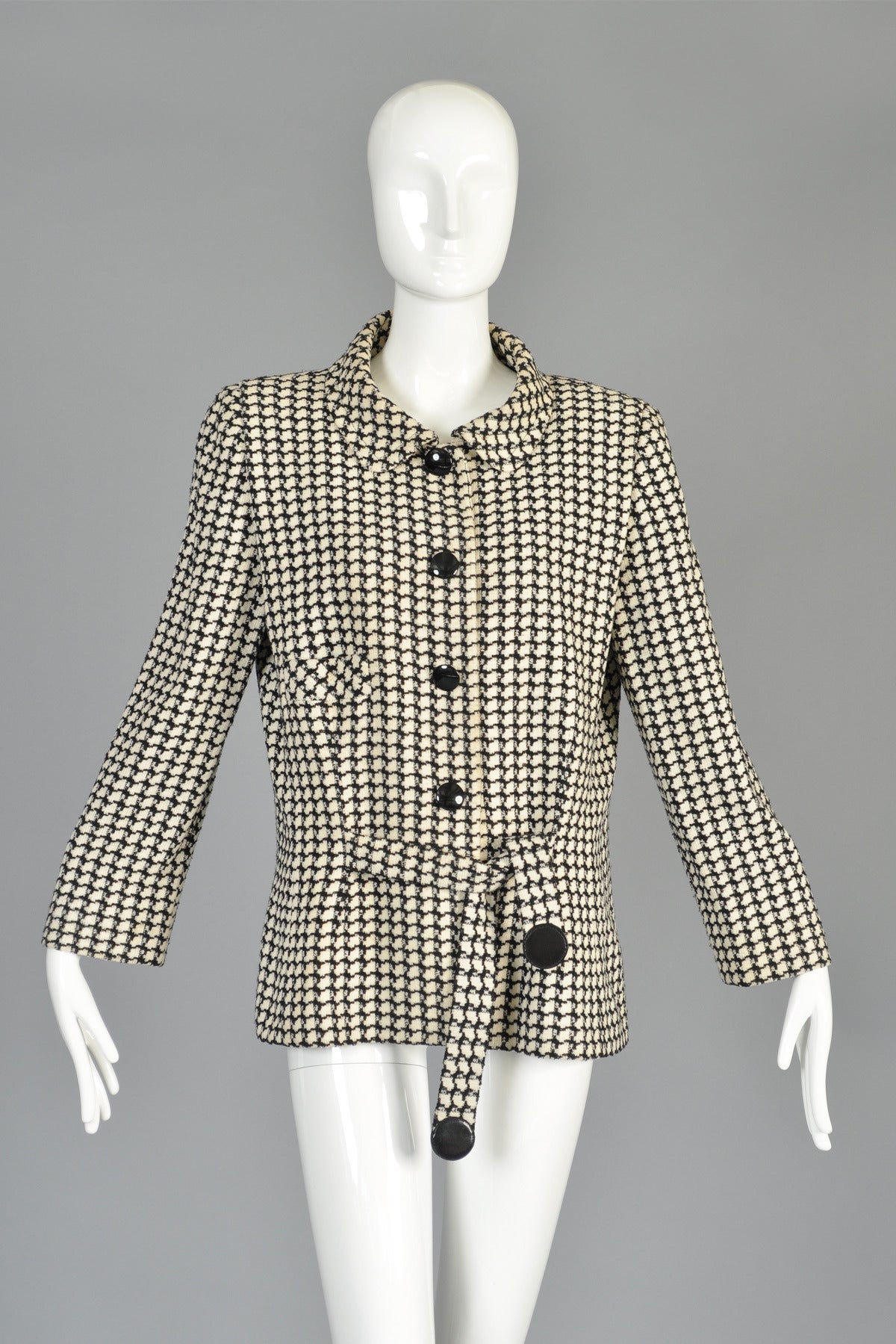 Absolutely awesome F/W 92/93 vintage Pierre Cardin haute couture houndstooth jacket. Button front with oversize shoulders, nipped waist and front ties with classic Cardin vinyl dots accenting the end of each tie. Mid-weight wool. Fully lined. Made