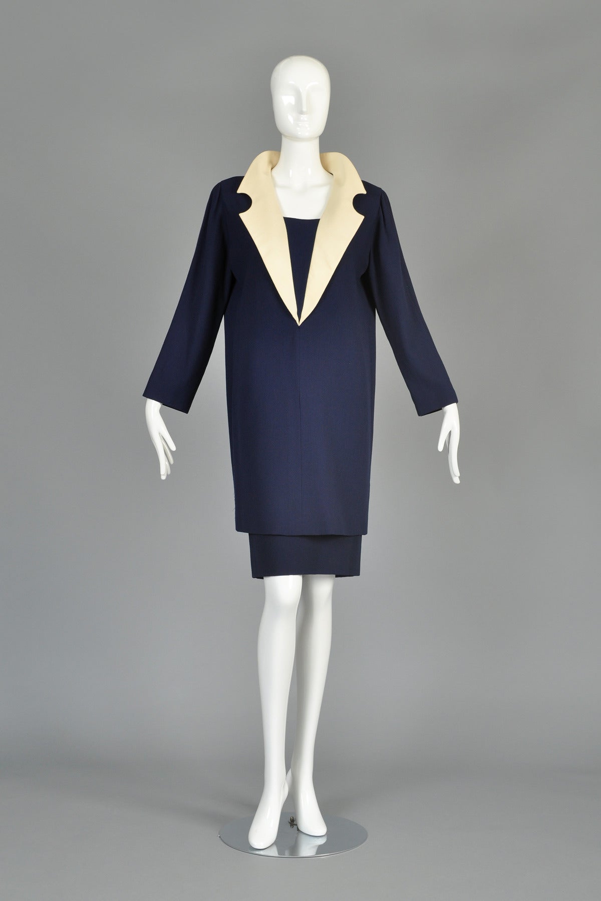 Circa 92/93 vintage Pierre Cardin haute couture ensemble. Incredible, extremely hard to find piece. Dark navy blue light to mid-weight wool crepe. Simple high-waist skirt tapers at the knee. Matching tunic features wide set shoulders and tapered