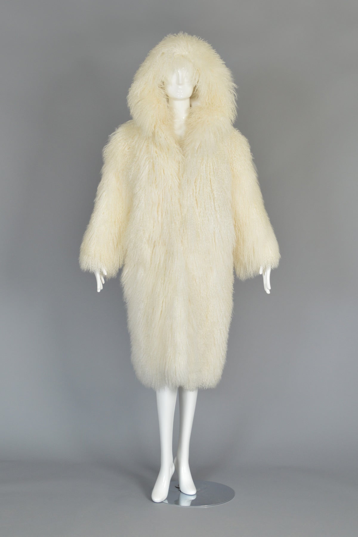 Seriously insane 1980s/early 90s Perry Ellis hooded Mongolian lamb fur coat. Possibly a Marc Jacobs designed piece. Extraordinary find! Beautiful ivory-colored ultra long genuine Mongolian lamb fur body with huge hood, hook + eye closures and besom