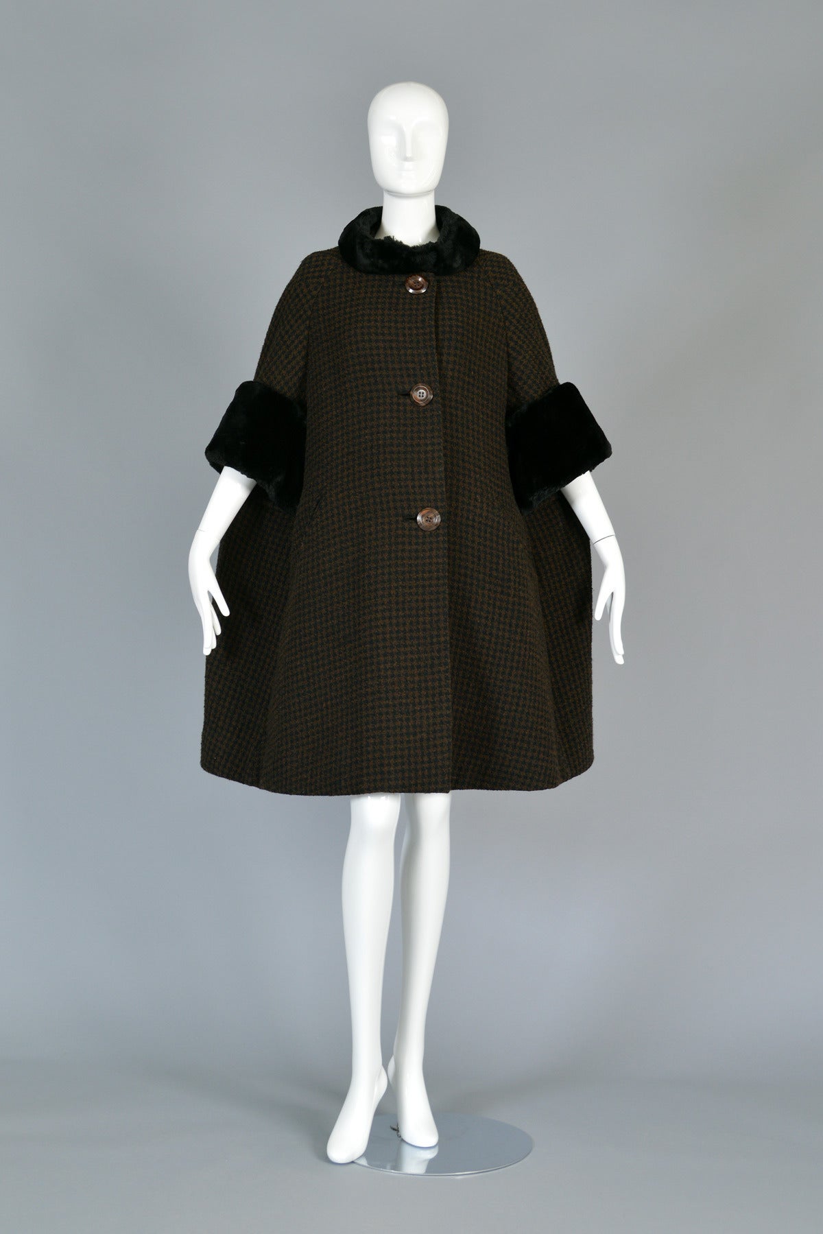 Ultra lovely vintage 1950s nutmeg and black checked wool swing coat. Such an amazing find! Incredible bell-shaped swing cut with button front and besom pockets. Ultra short sheared beaver sleeves and tab collar. Pristine vintage