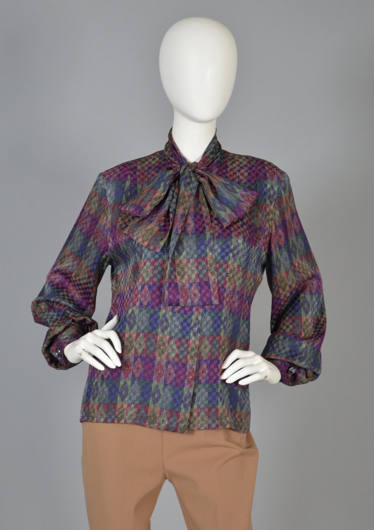 Gorgeous late 1970s/early 80s graphic silk blouse by Givenchy. Fantastic piece with the most amazing pattern! Incredible diamond pattern looks basket woven but isn't - such an incredible textile! Puffed sleeves, hidden buttons up the front and