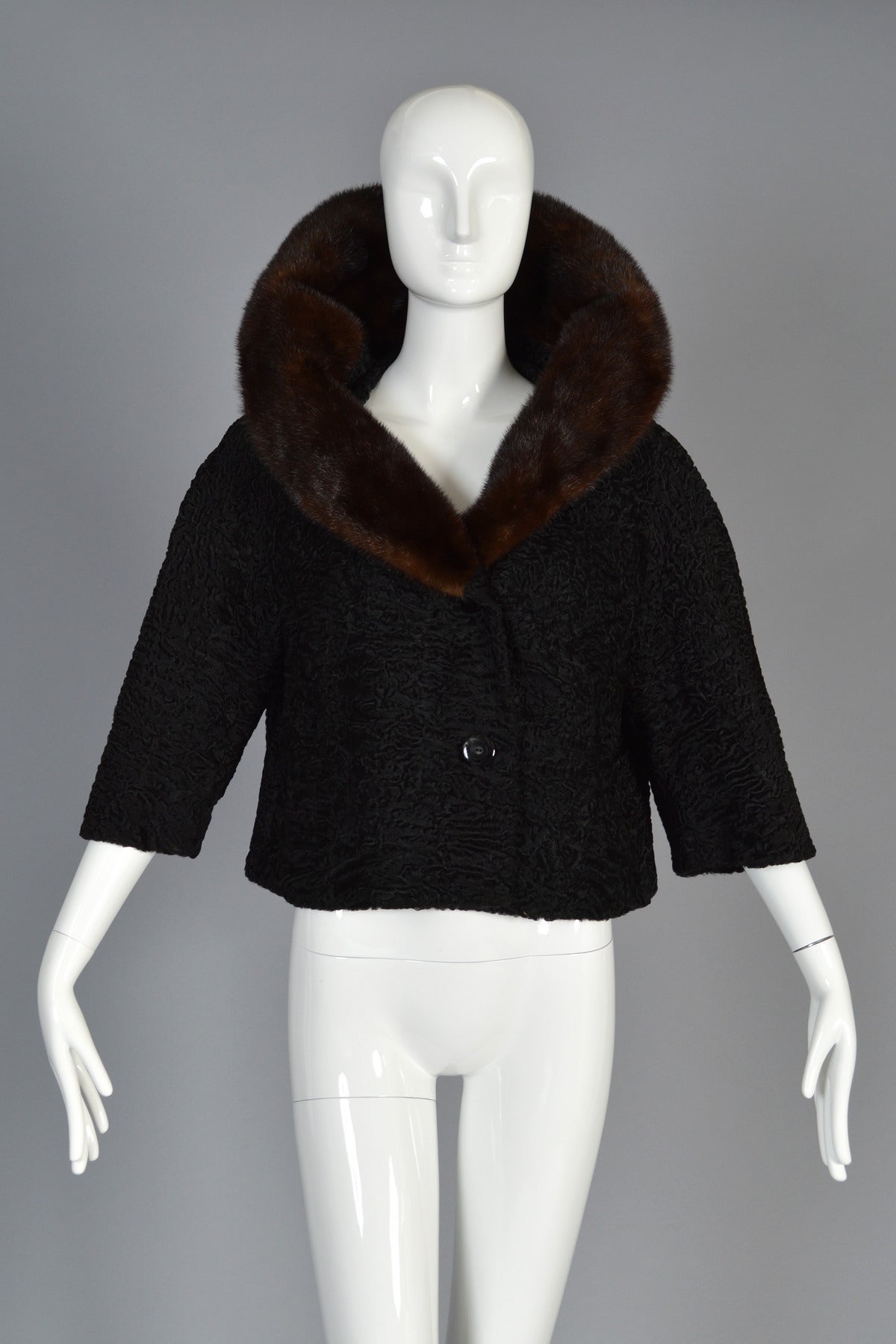 Lovely 1950s/60s Elsa Schiaparelli fur coat. BEAUTIFUL find! Short, cropped Persian lamb fur body with 3/4 sleeves, wide cut and MASSIVE lamb-backed mink collar. Also features double button front and simple besom pockets. Truly a simple + chic
