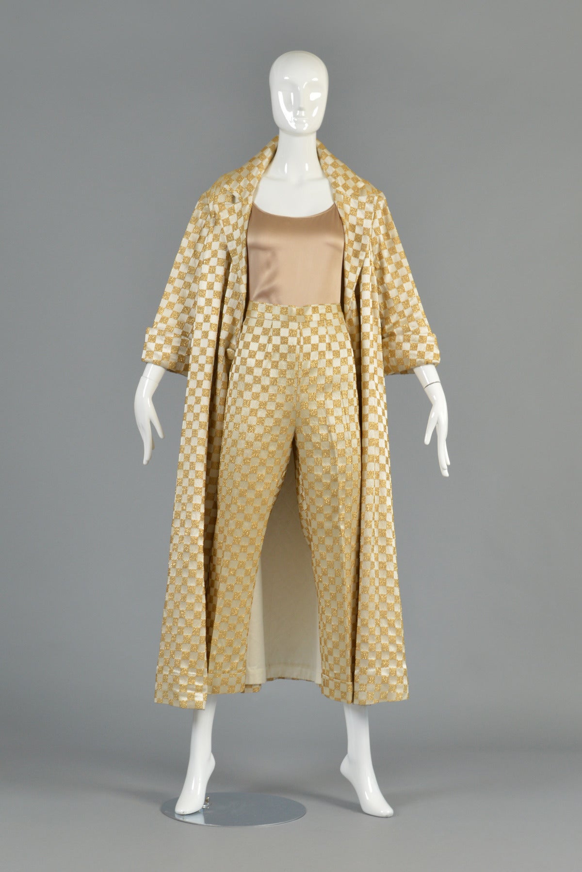 Recently reduced from $695 to $395

Seriously incredible 1960s ivory and gold checkerboard brocade ensemble. One-of-a-kind hand tailored find! Ultra high waisted, wide legged trousers with side zipper, wide legs and cuffed hem. Matching