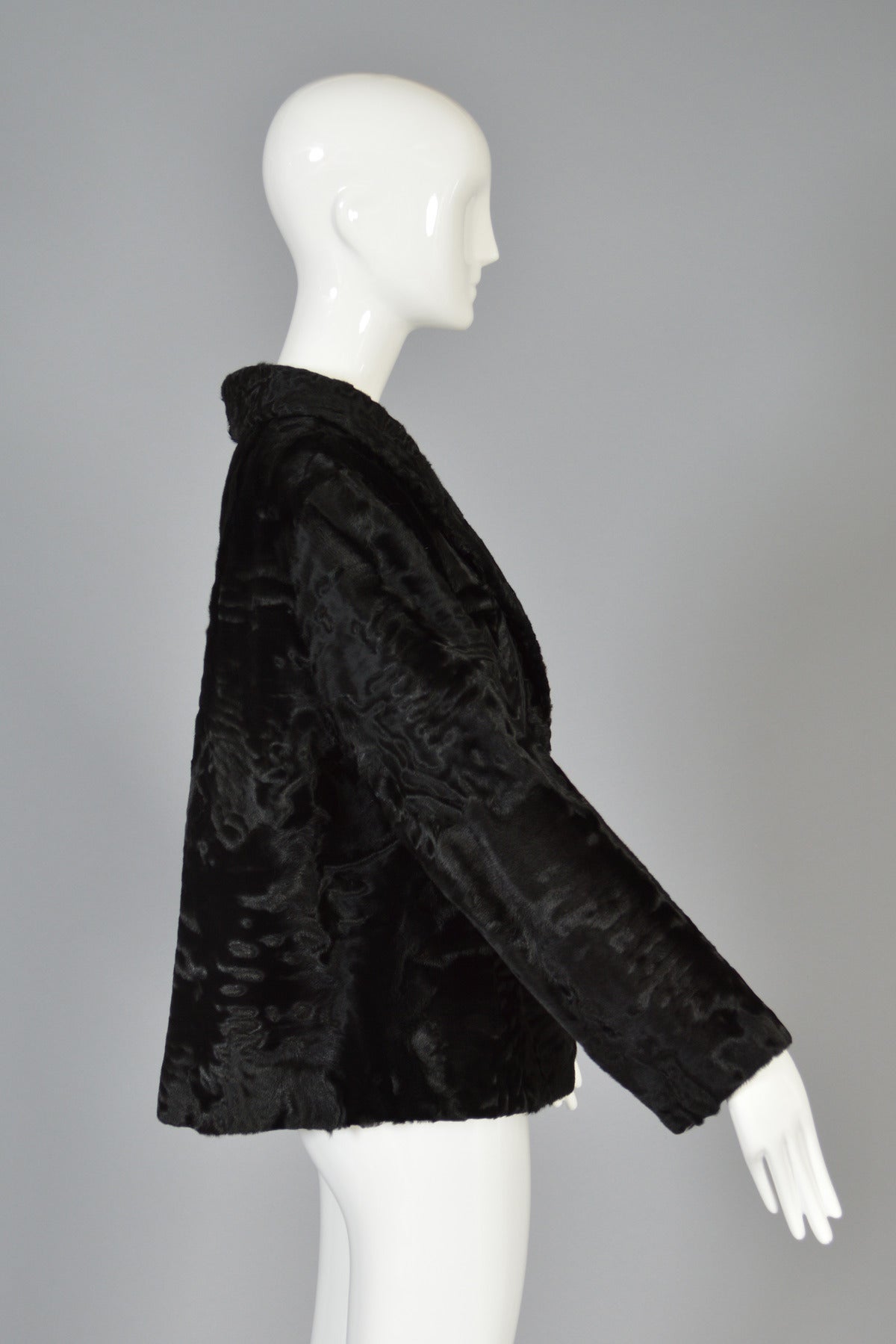Superb 1950's cropped black broadtail jacket. Broadtail is EVERYTHING this season! Extremely high quality, velvety soft broadtail lamb fur. Ultra modern boxy cropped cut with a slight flare. Hidden asymmetric fur closures. Fully lined. Broadtail is