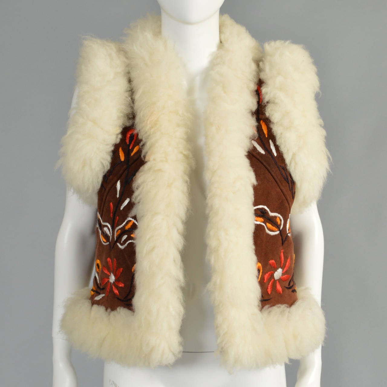 Super super adorable vintage 1960s/70s embroidered shearling vest. Such a fantastic find - extremely high quality shearling! Super short cropped length with floral and leaf pattern. Shearling trim and full shearling inside as well. Pristine vintage