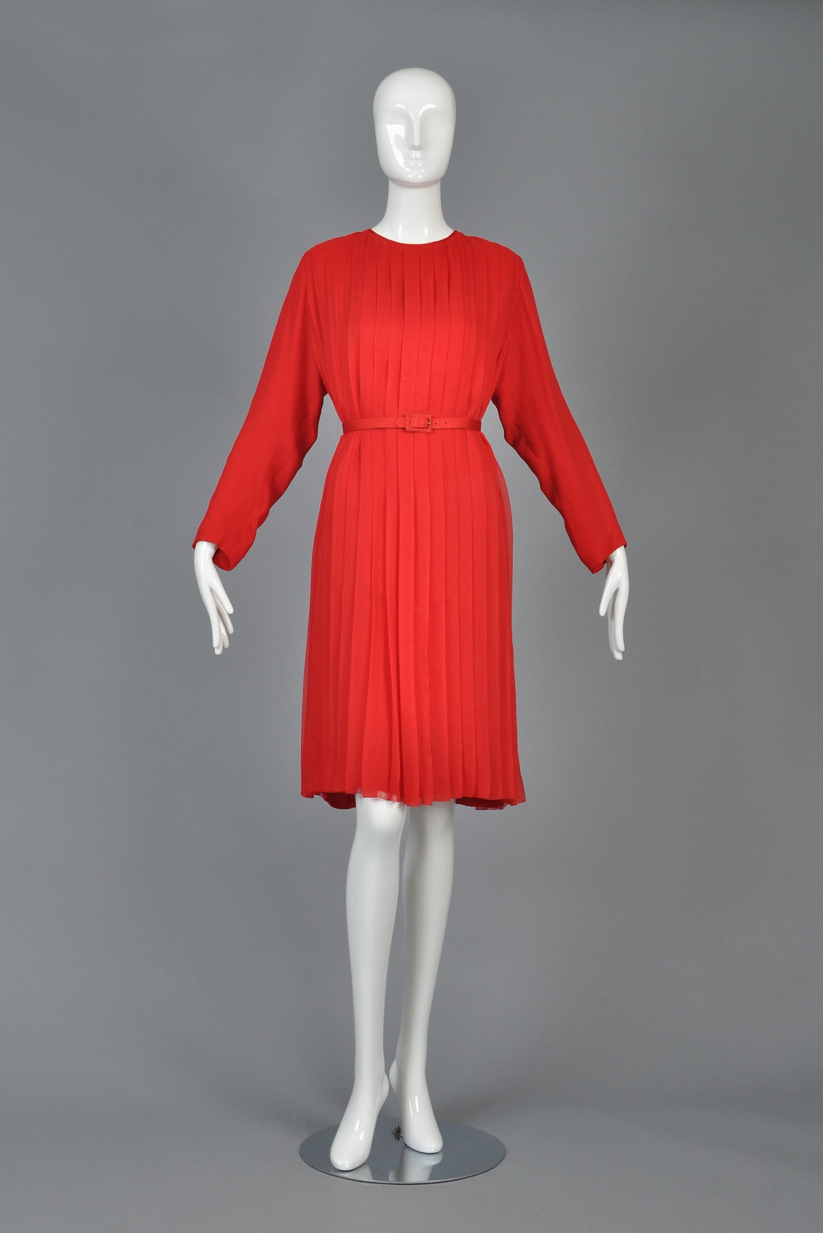 Incredible vintage 1980s silk dress by James Galanos. Ruby red silk. Fantastic full sheath shape. Fully pleated. Looks great belted (belt not included) or as is. Excellent vintage condition.

MEASUREMENTS
Bust: 41