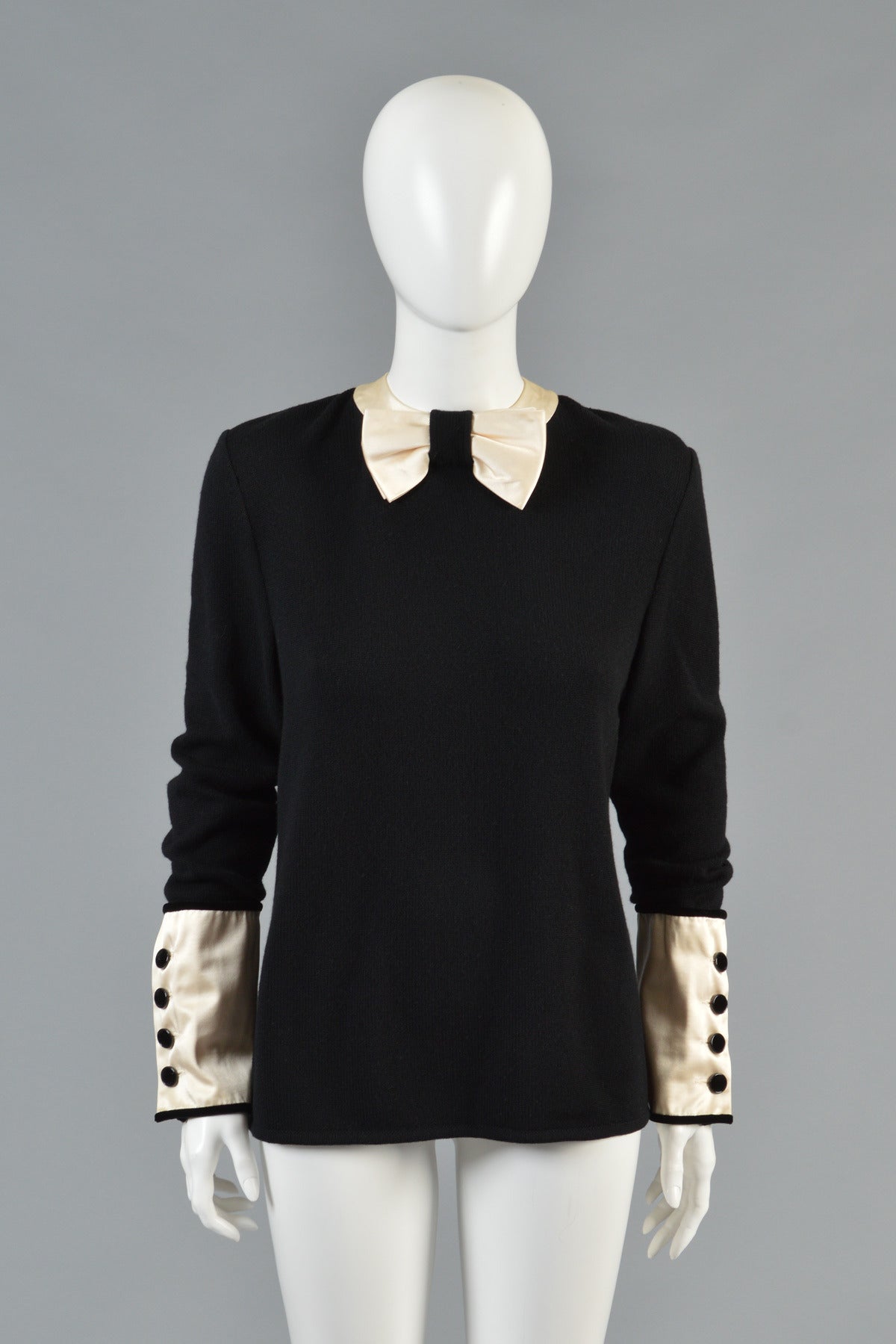 Recently reduced from $590 to $395

Everyone loves a tuxedo themed dress, jacket or top and we are so happy to have this 1980's Valentino cashmere and silk sweater! One of the cutest sweaters we've had to date!

Simple slightly-boxy cut black