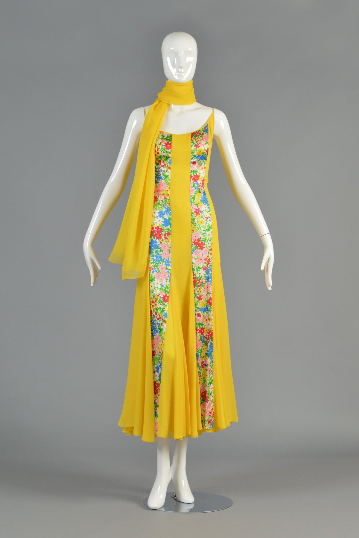 Beautiful 1970's silk chiffon gown by Galanos. Absolutely stunning piece on and yellow is EVERYWHERE this season!

Dress features low scooping neckline with spaghetti straps and massively flared skirt. Bright yellow silk chiffon with inset panels