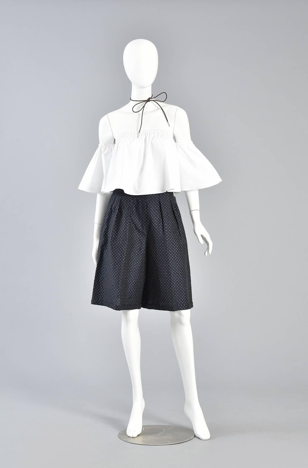 Navy Blue & White Flared Polkadot Shorts

Bustown Modern is so happy to offer these super cute 1980s polkadot culottes. High waisted navy blue culottes with with pleated top, flared shorts, cuffed hem and side pockets.

Excellent vintage