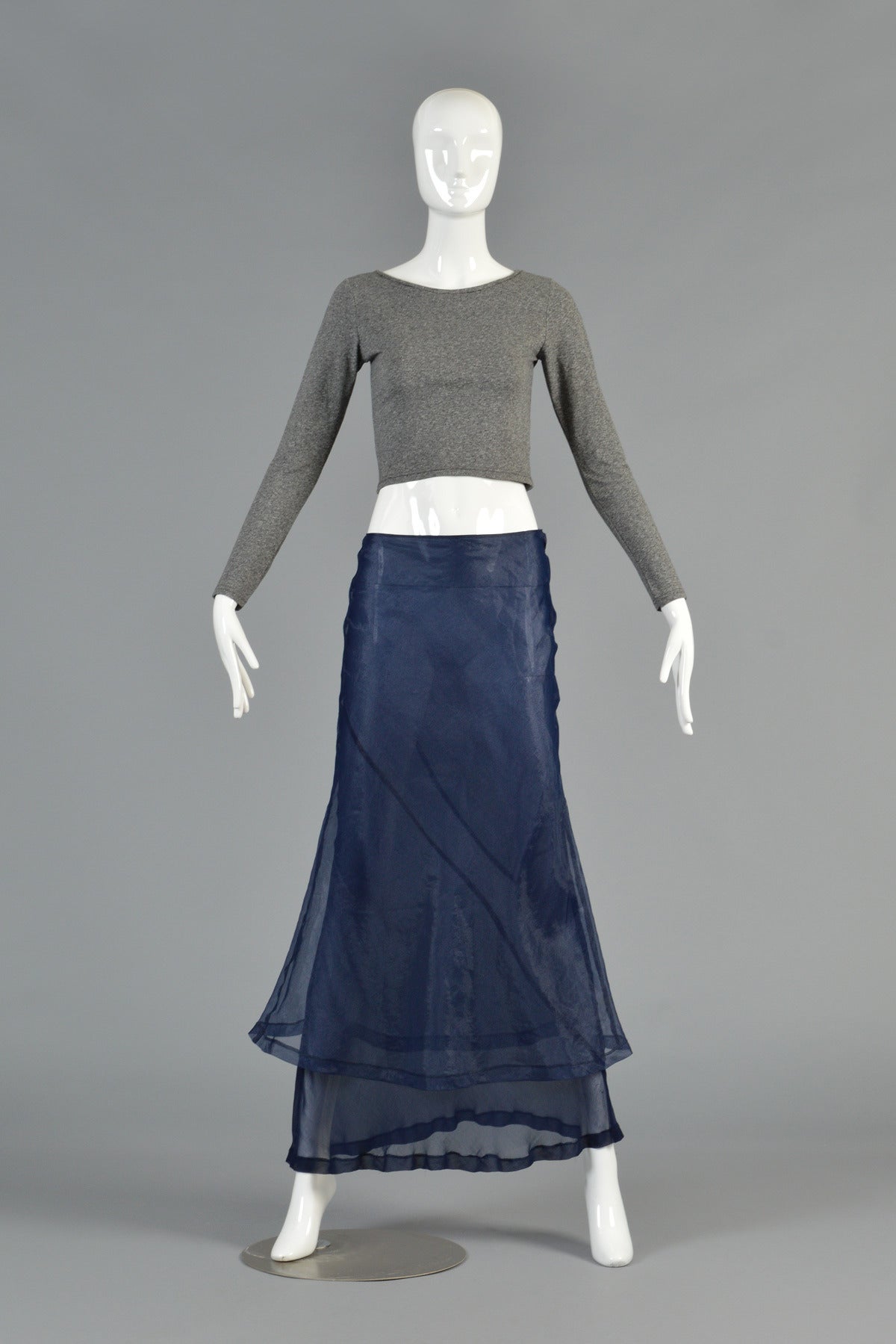 Killer A/D 1997 Comme des Garcons bi-level maxi skirt. Exquisite semi-sheer  shimmery blueberry color.  Crinkled synthetic.  High waist with side zipper. Unworn vintage condition. 

MEASUREMENTS
Waist: 28