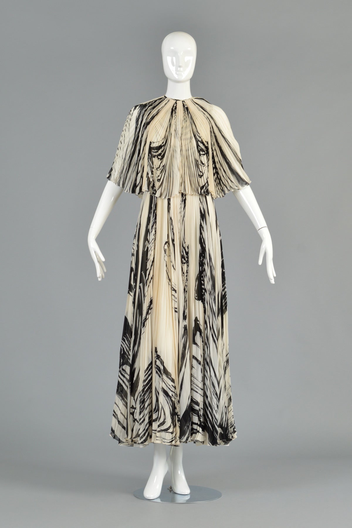 Show-stopping vintage 1960s silk gown by La Mendola. Stunning floor length maxi gown with fully pleated, full-sweep skirt. Matching pleated capelet jacket. Incredible black + white graphic pattern. Made in Italy. Definitely red carpet worthy -- one