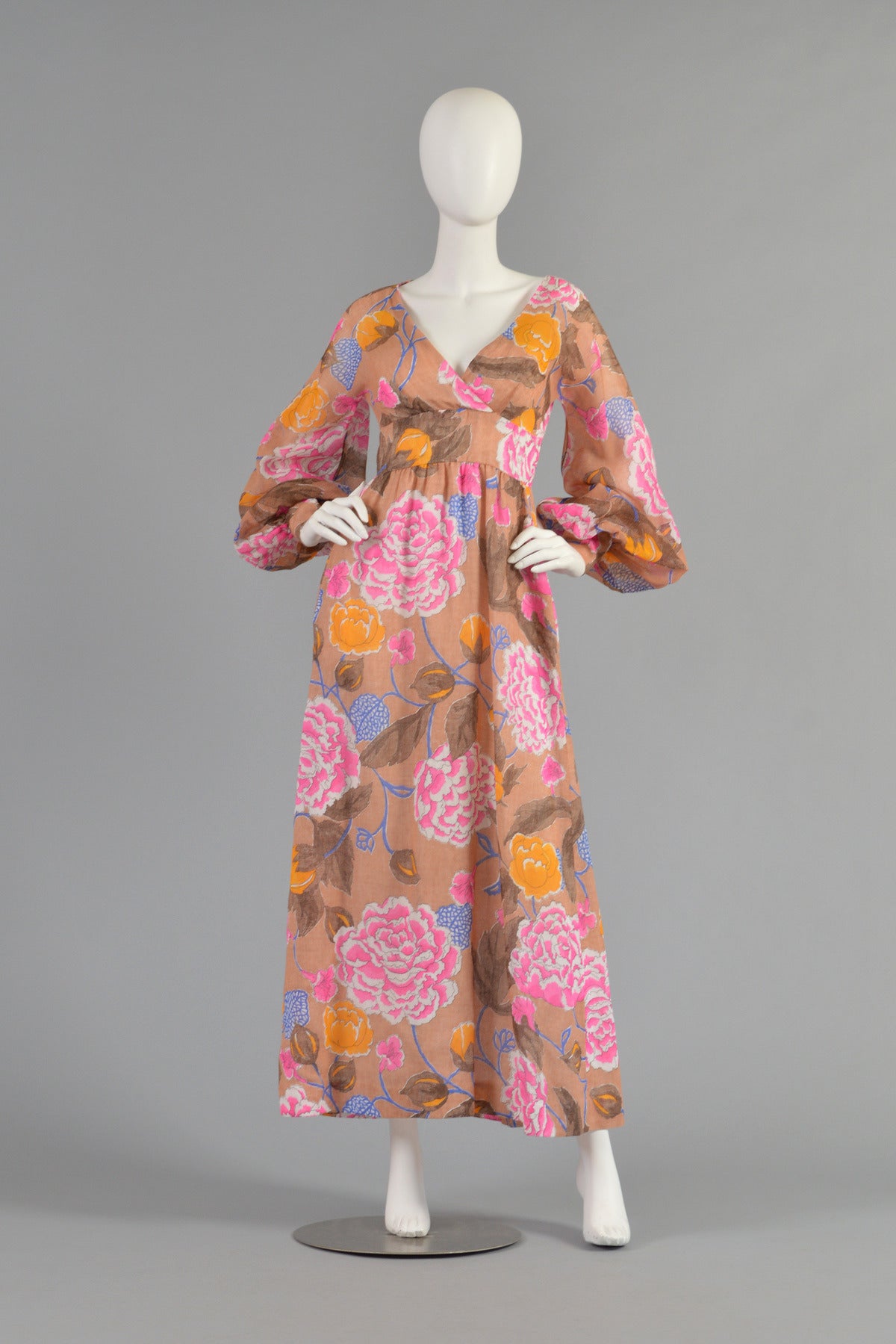 Beautiful 1970's Rizkallah for Malcolm Starr cotton gauze maxi dress. Incredible piece with the most beautiful color palette. Plunging crossover neckline with puffed sheer sleeves and flared skirt. Synthetic zipper in back. Fully lined throughout