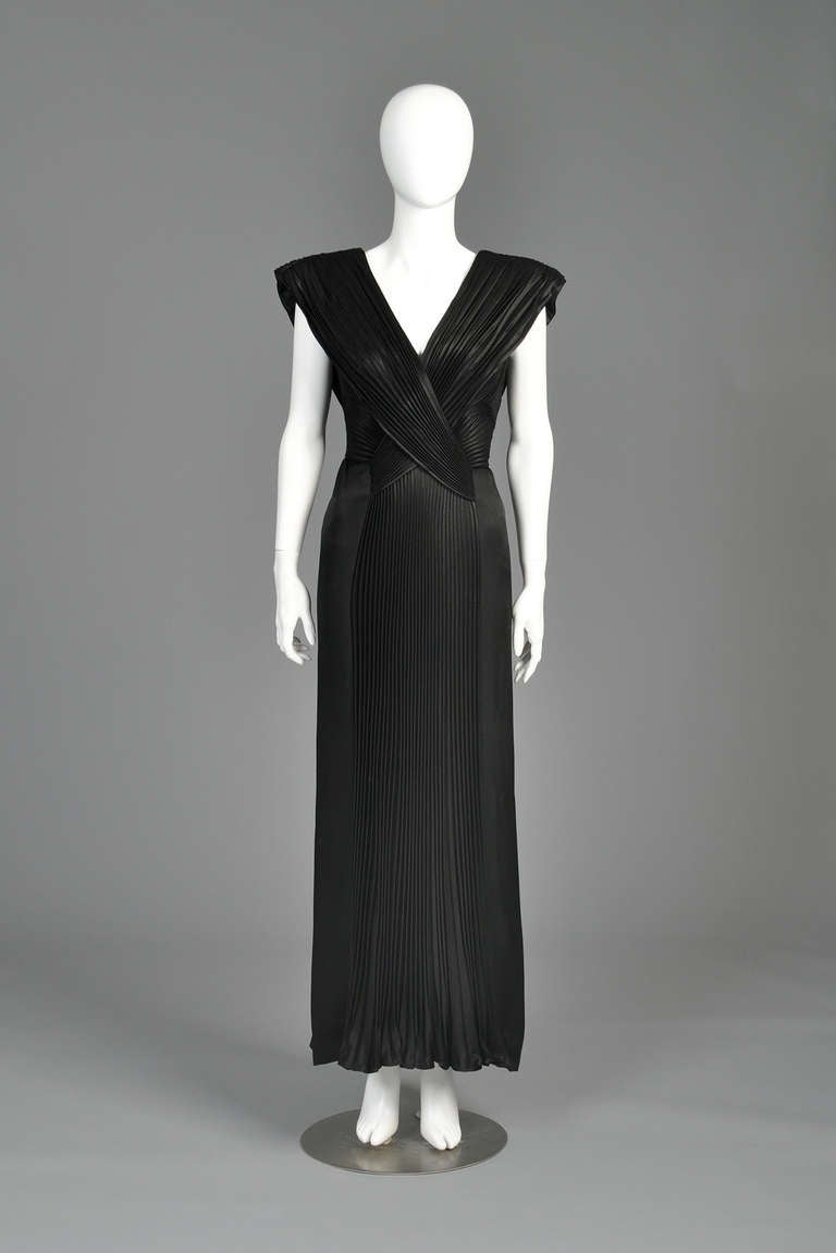 Just reduced from $1200 to $600

Stunning Loris Azzaro 1980s pleated evening gown. INCREDIBLE construction! Plunging crossover pleated neckline with crystal pleated inserted skirt. We love the sculptural appeal of the bodice! AMAZING movement.