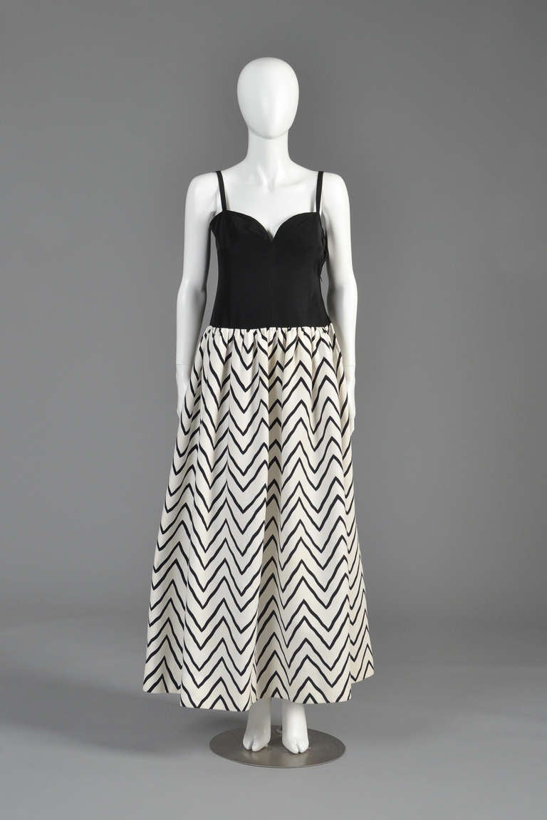 Just reduced from $1200 to $800

Spectacular S/S 1980 Yves Saint Laurent evening gown. Solid black ultra fitted moiré faille bustier topce with sweetheart neckline and spaghetti straps. Ultra full, heavy-weight chevron-striped cotton skirt. We