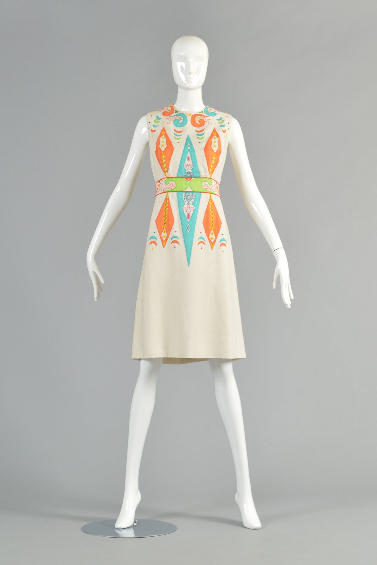 Incredible circa 1964 vintage Christian Dior dress. Ultra fitted linen-weave sheath dress with silk applique. Sheer orange, aqua + lime colored applied silk  panels, each hand stitched into place. Embroidered cutwork diamond + triangle shapes