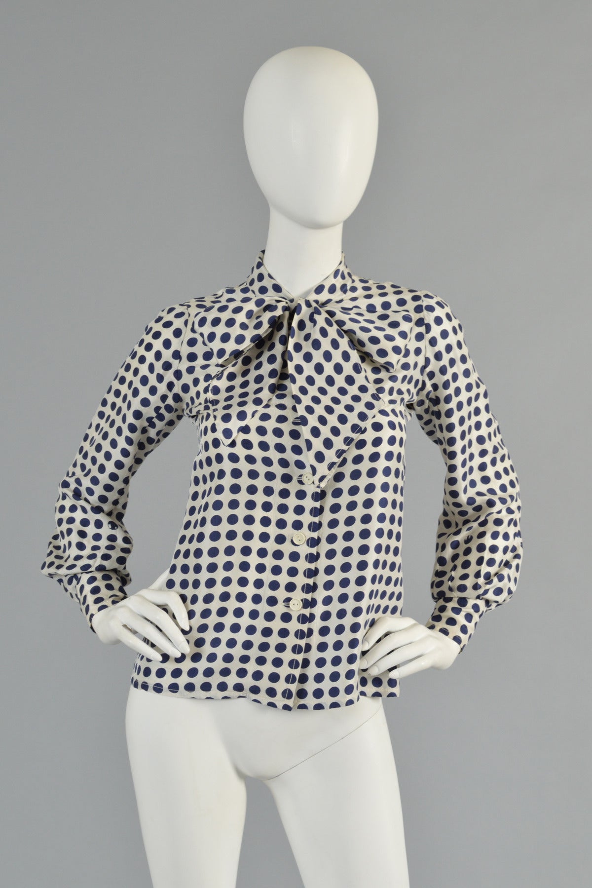 Darling vintage late 60s/early 70s silk blouse by Emanuel Ungaro. White silk body with hand-screened navy blue polkadots. As seen in the next to the last photo, due to the hand-screened nature, some of the polkadots have slight imperfections. Large
