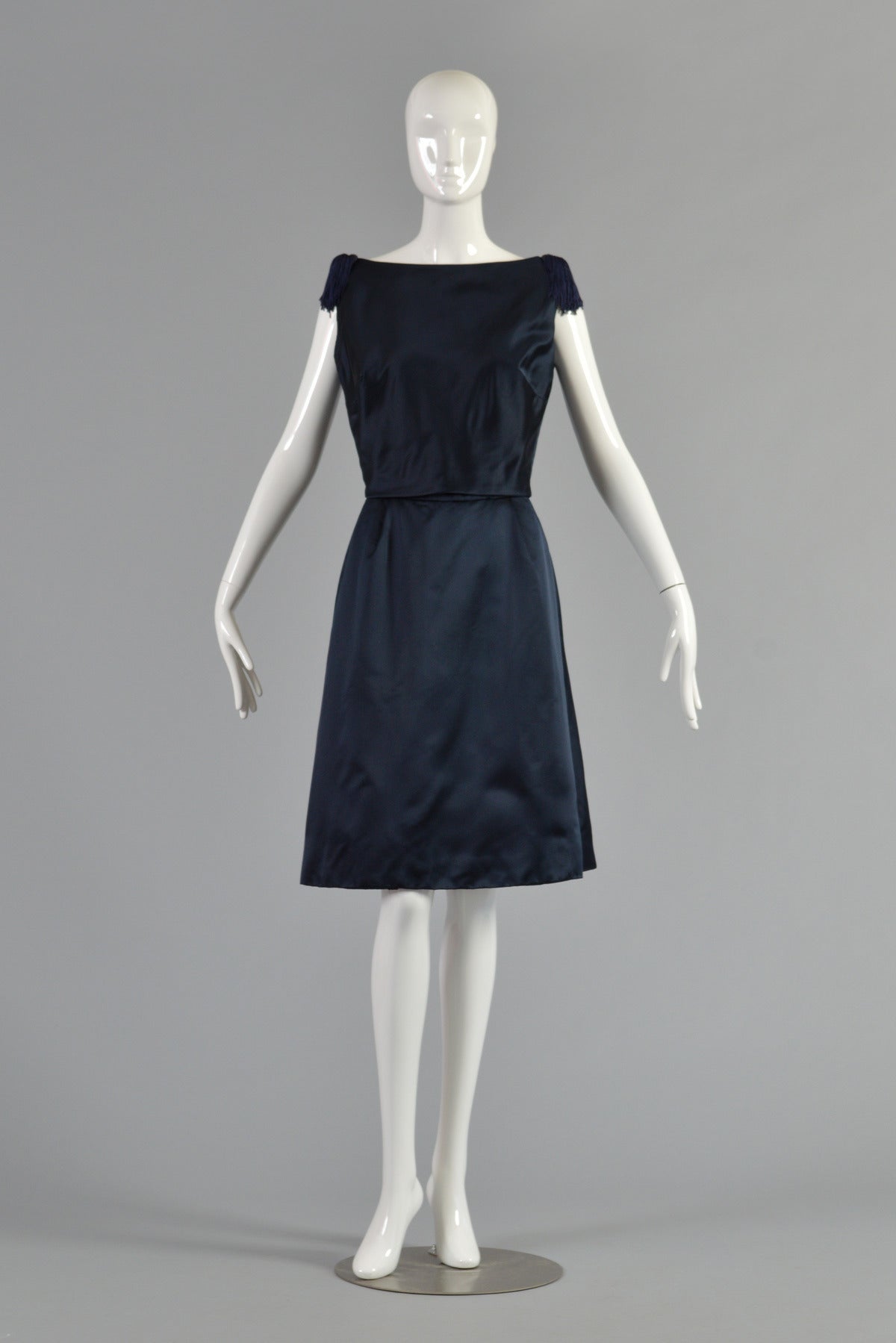 Beautiful vintage 1950/60s cocktail dress by Karen Stark for Harvey Berin. Gorgeous midnight blue silk satin. Tiered bodice with button back. Fringed tassels at shoulders. Panel-front skirt. A stunning + versatile dress. Excellent condition. Best