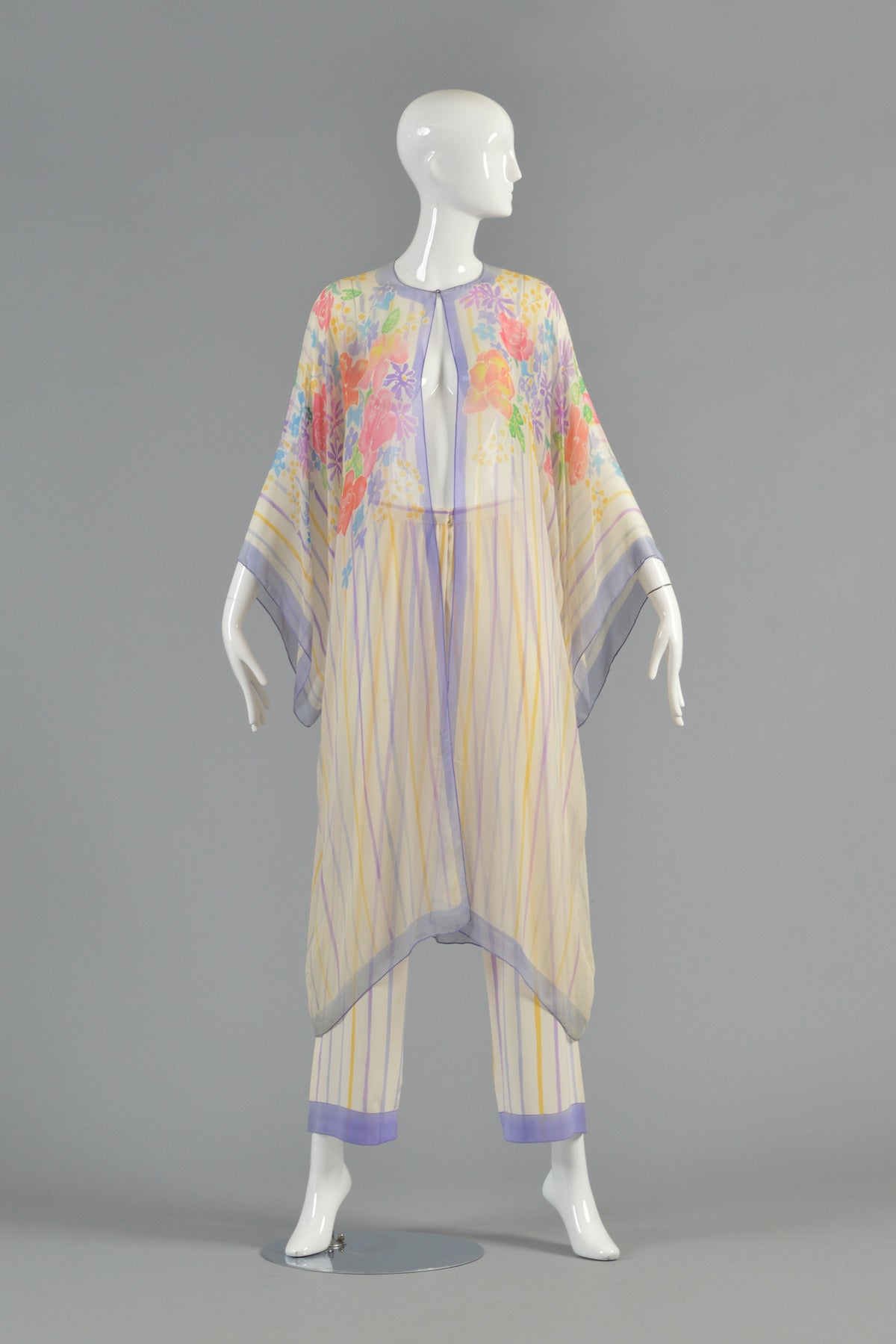 Exquisite Oscar de la Renta Hand Painted Silk Kimono Ensemble. Includes high-waisted, wide-legged striped silk pants and matching sheer silk, hand-painted kimono jacket. Jacket features wide kimono sleeves, hand-painted stripes amidst a bouquet of