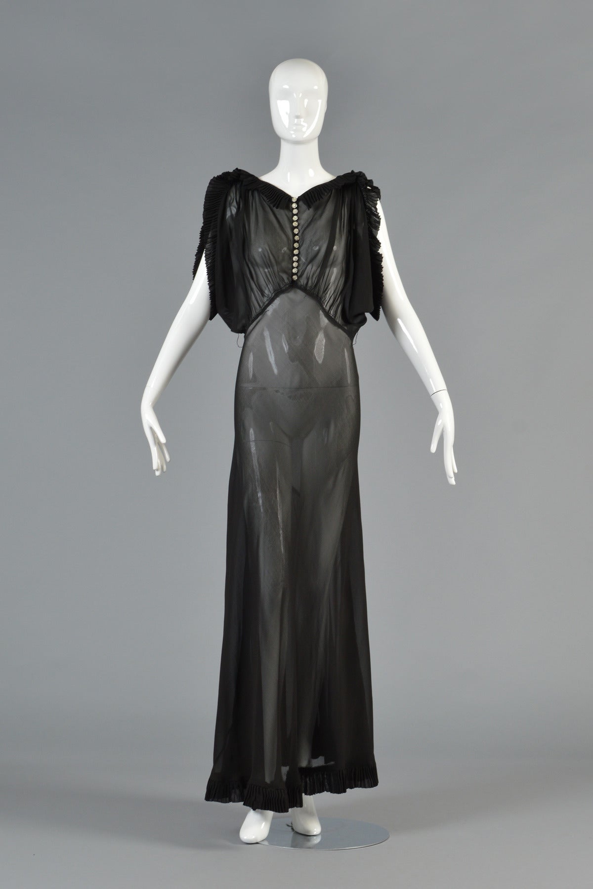Beautiful 1930's sheer black evening gown. AMAZING construction and so elegant! The dress features a gathered bodice with incredible tiny micropleating around the shoulders, sleeves and hem. Note the avant garde manner in which the pleats stand