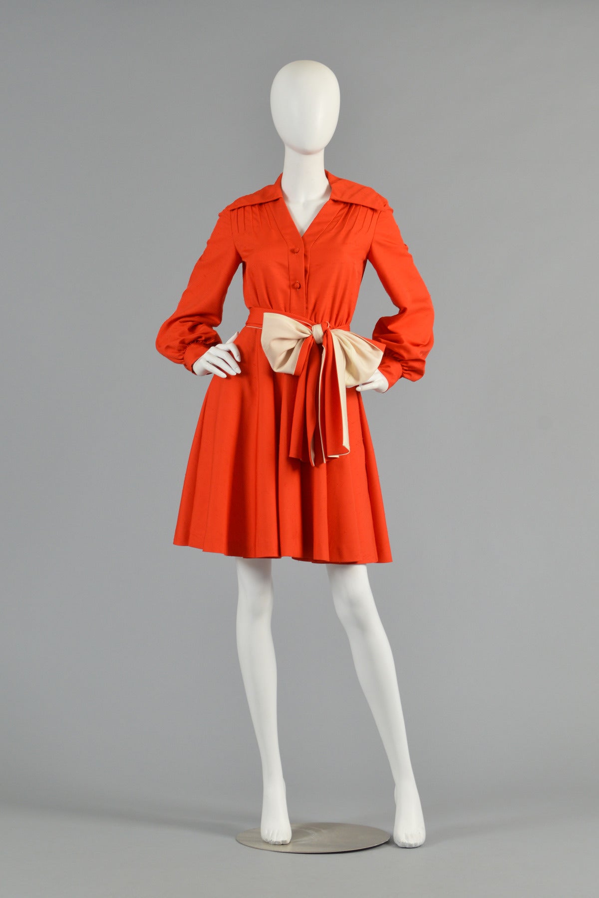 Adorable 1970s poppy colored raw slubbed silk dress by Geoffrey Beene. Such a great find! Bodice is super fitted with button front, v-neck and oversize flat collar. We absolutely love the pin-tucked details at the shoulder and the long bishop