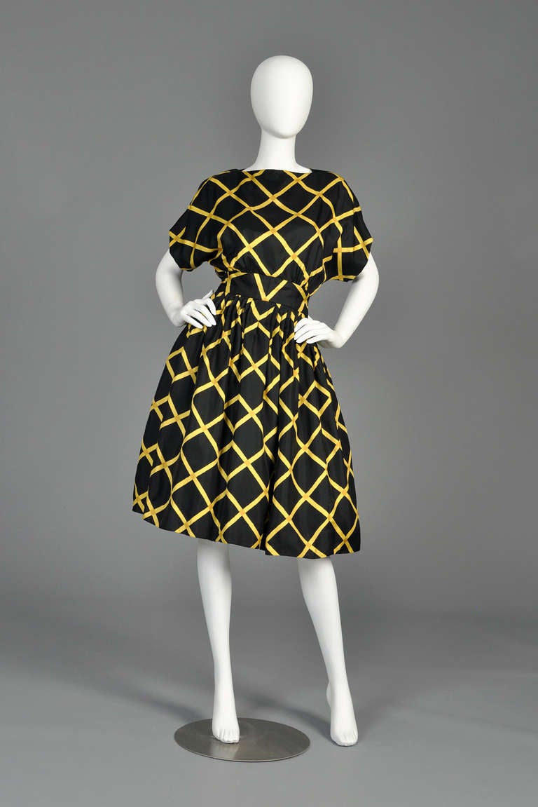 Lovely vintage 1960s Pauline Trigere graphic silk party dress. Adorable little piece! All silk with kimono-esque top, nipped waist and full skirt. Fully lined in silk Shown with a small crinoline to maximize fullness. Excellent vintage condition.