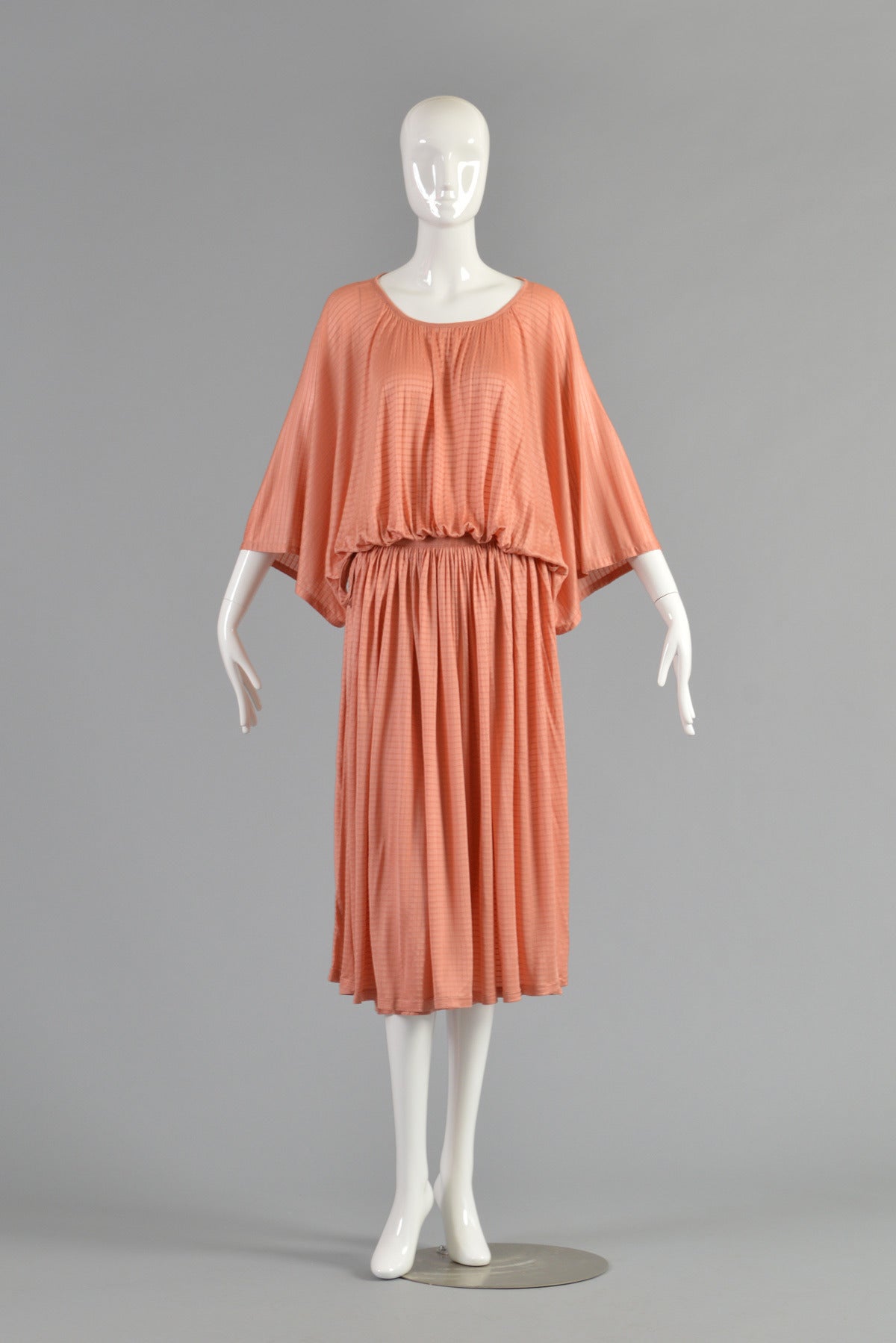 Lovely 1970s 2-piece silk ensemble by Missoni. The BEST color of the season! Ultra draped silk tunic too with kimono sleeves features a gathered waist and open sided attached skirt that ties on each side. The entire top portion sits atop a simple