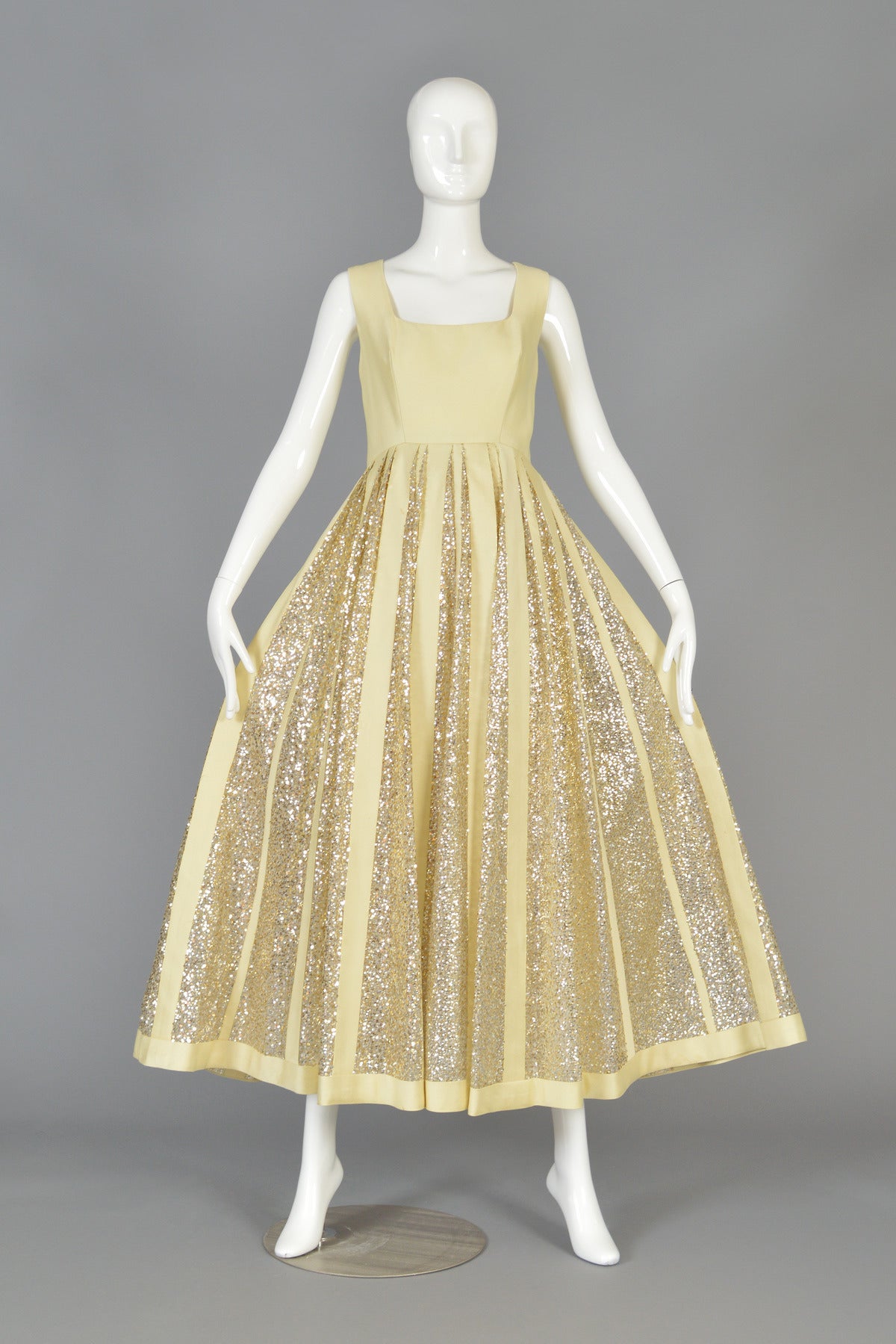 Absolutely beautiful 1960's evening dress. Such an incredible piece. Pale shimmery gold silk shantung and contrasting silvery sequins! Fitted bodice with squared neck and massive full skirt. The construction of the skirt is particularly interesting