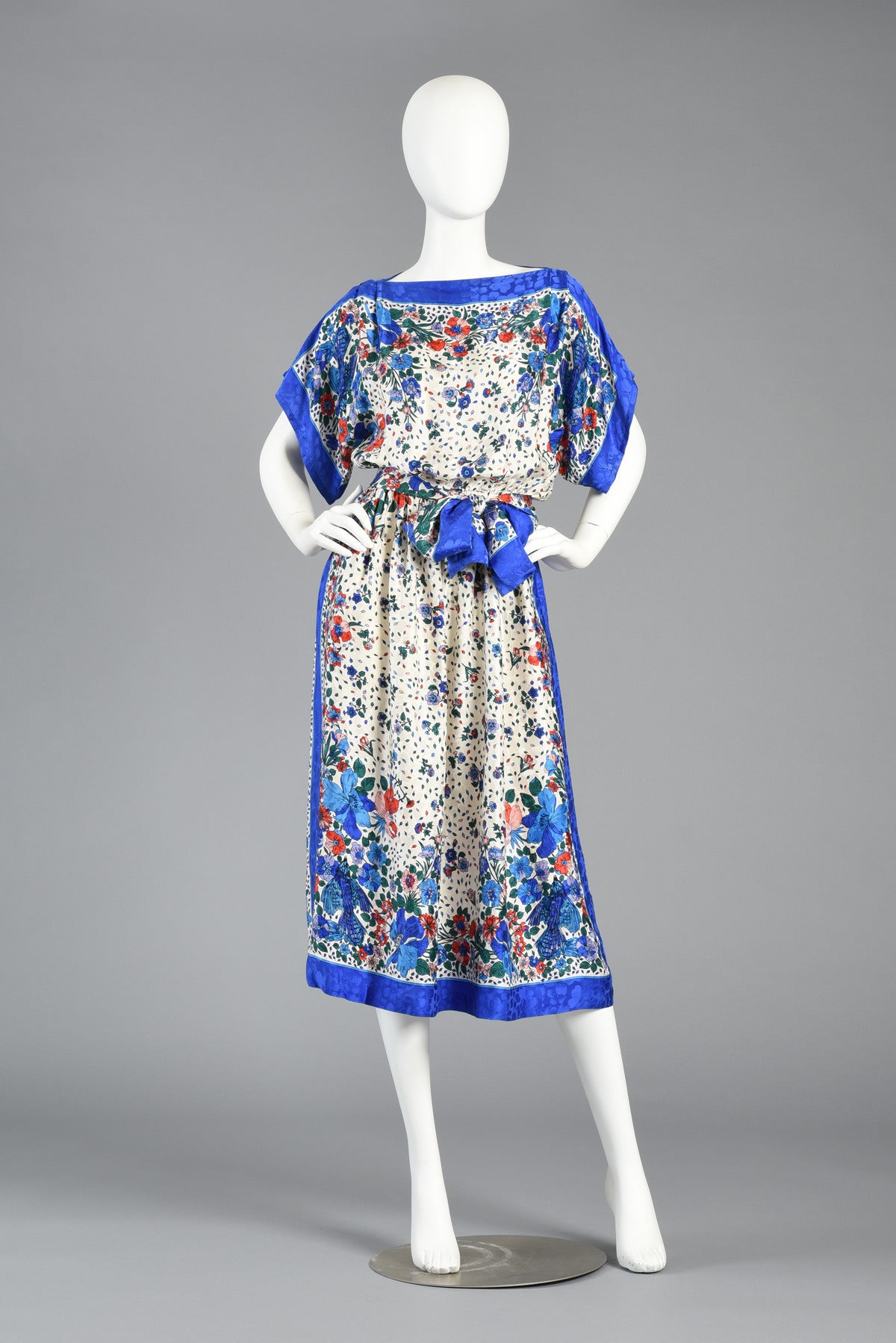 We love this little 1980s silk scarf dress. It's such a happy, cheerful piece and great for most spring and summer events. The perfect dress for a lovely garden party!

Silk dress features a bateau neckline with kimono-esque sleeves, and cinched