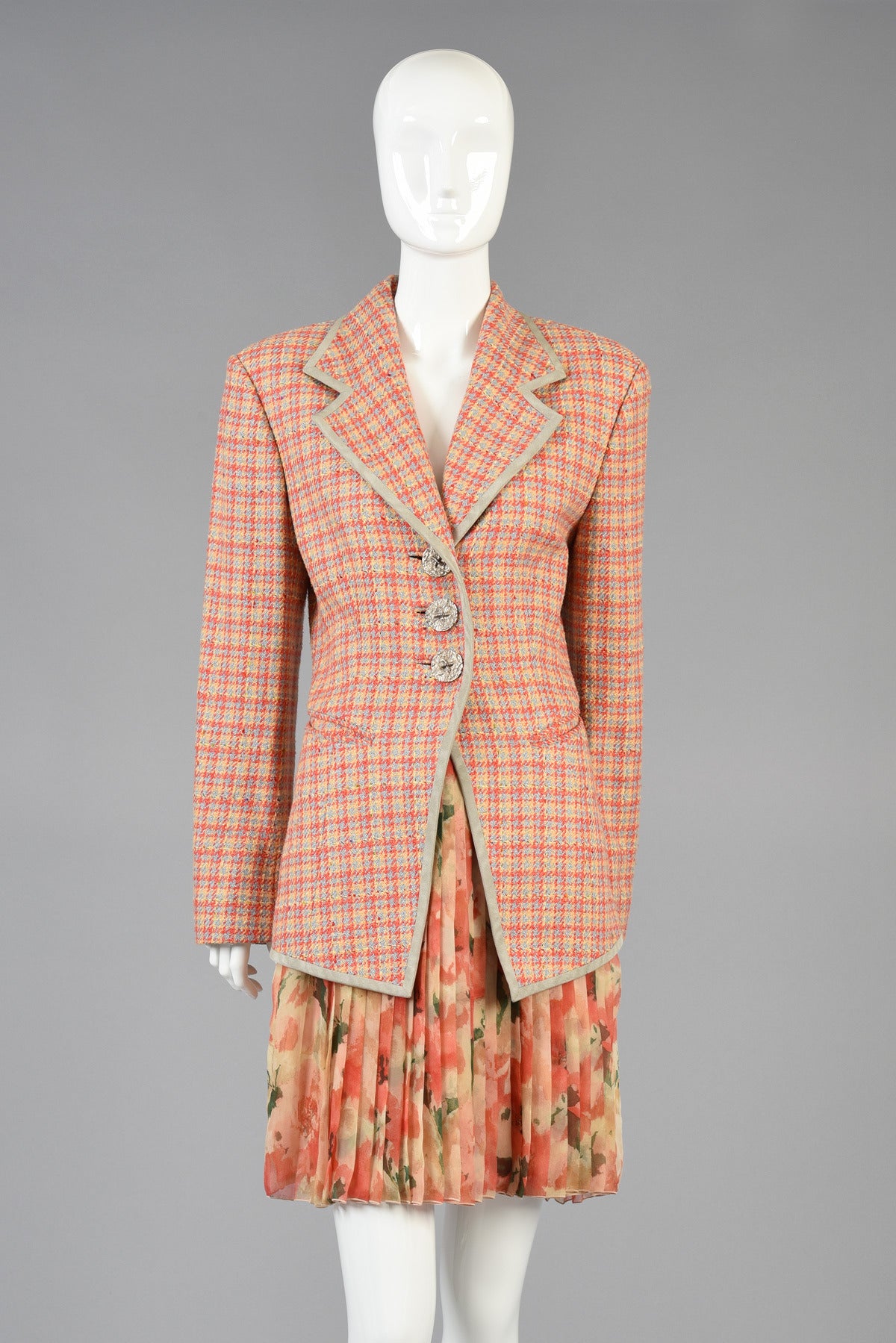 Super cute 1990's Christian Dior Boutique numbered houndstooth jacket. Super awesome find and easy to style with any wardrobe! Pale coral, grey and yellow houndstooth body with grey silk trim and oversized silver metal buttons.  Fully lined in silk.