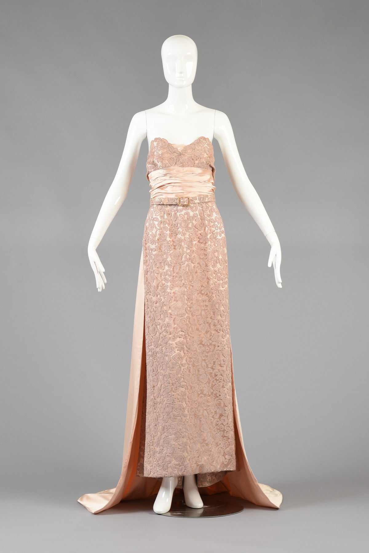 We are so pleased to bring you this circa 1952 Pierre Balmain demi-couture evening gown -  there's no other way to describe this gown than to simply call it dreamy. Layers of varying shades of pink silk and lace in addition to its long silk train