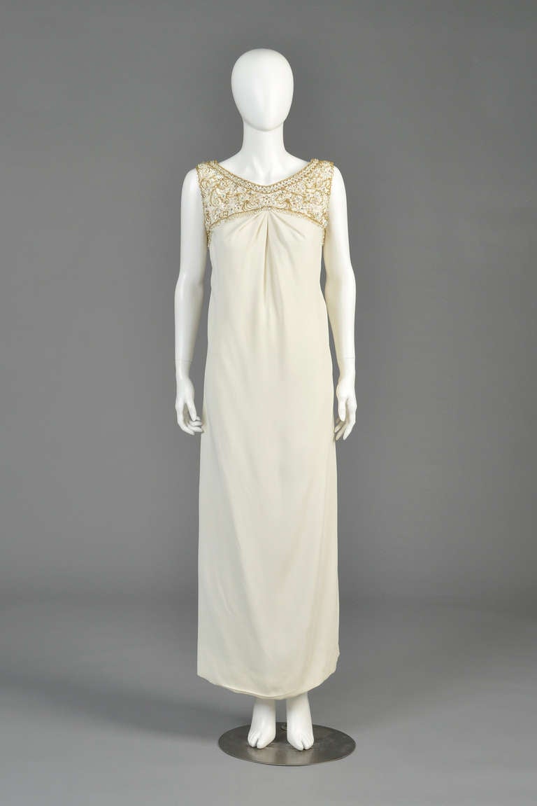Lovely 1960s Malcolm Starr ivory gown with beaded yoke. Simple + chic. High beaded neckline with gathered bust and simple shift cut. Huge side slit. Metal zipper in back. Fully lined. Excellent vintage condition. Freshly cleaned and ready to wear.