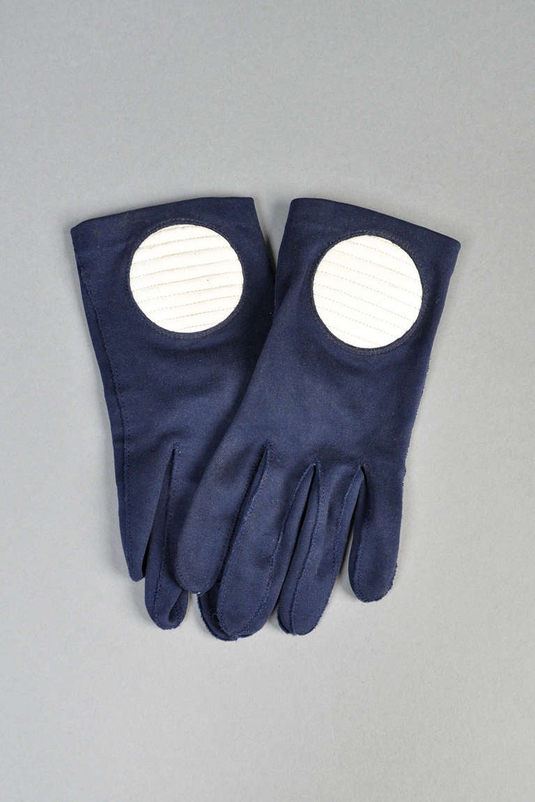 Killer 1960s Pierre Cardin mod gloves. Hard to find, coveted item! Dark navy blue body with just enough stretch and snapping closure at wrist. Huge quilted vinyl circles on the wrist. Marked size 7.

MEASUREMENTS
Length:	7.5