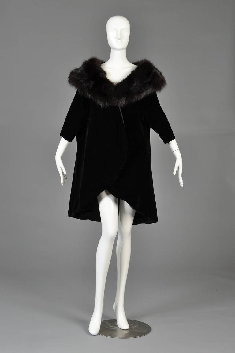 Just reduced from $795 to $395

Absolutely gorgeous 1960s Mr. Blackwell Black velvet swing coat with MASSIVE dyed fox fur collar. Classic dolman sleeves with tapered front hem + rounded lapels. Massive swing shape in the rear. Excellent vintage