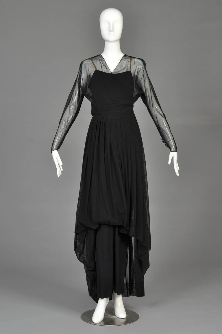 Absolutely stunning  early 1940s Hattie Carnegie 2-piece evening gown. Black draped rayon under dress with amazing details (that by today's standards could easily be worn on its own) features a side zipper, nude straps, low-cut back + pleated