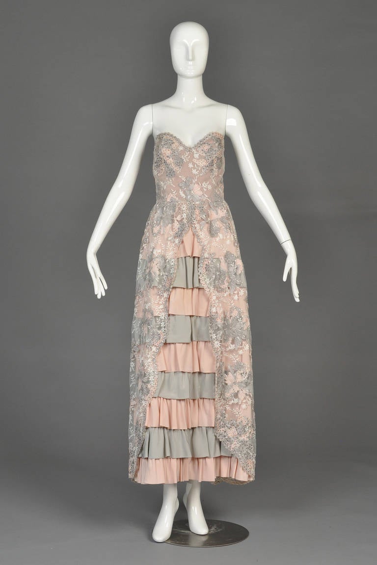 Just reduced from $895 to $495

Truly spectacular very circa 1980 evening gown. Truly a spectacular, one-of-a-kind French hand tailored find! This piece features a pale grey and blush colored striped tiered silk skirt with beaded ribbon/soutache