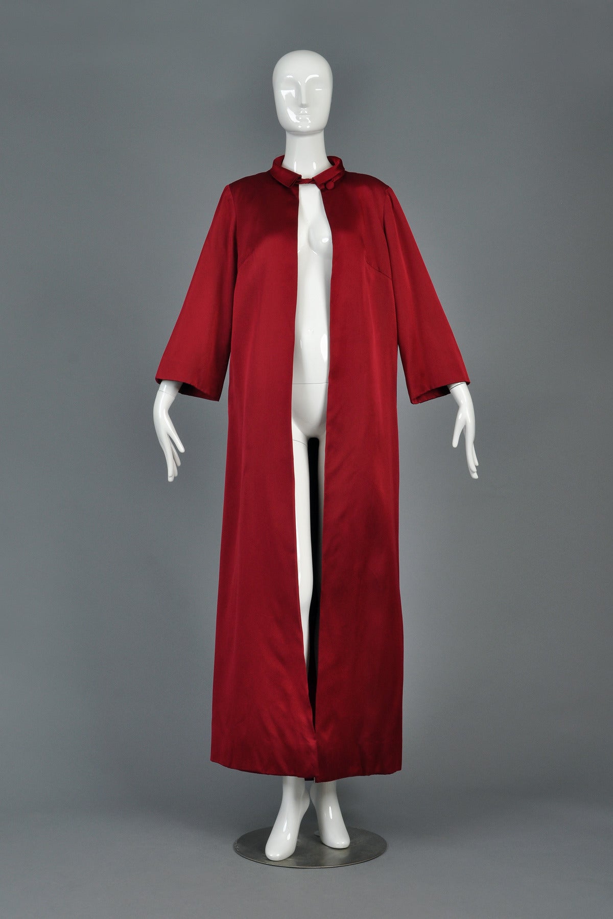 Spectacularly gorgeous 1960s full length crimson silk opera coat. Entirely hand tailored, amazing piece! Extremely heavy weight duchess silk satin with bracelet length pagoda sleeves and single closure at the neckline. Fully lined in the same