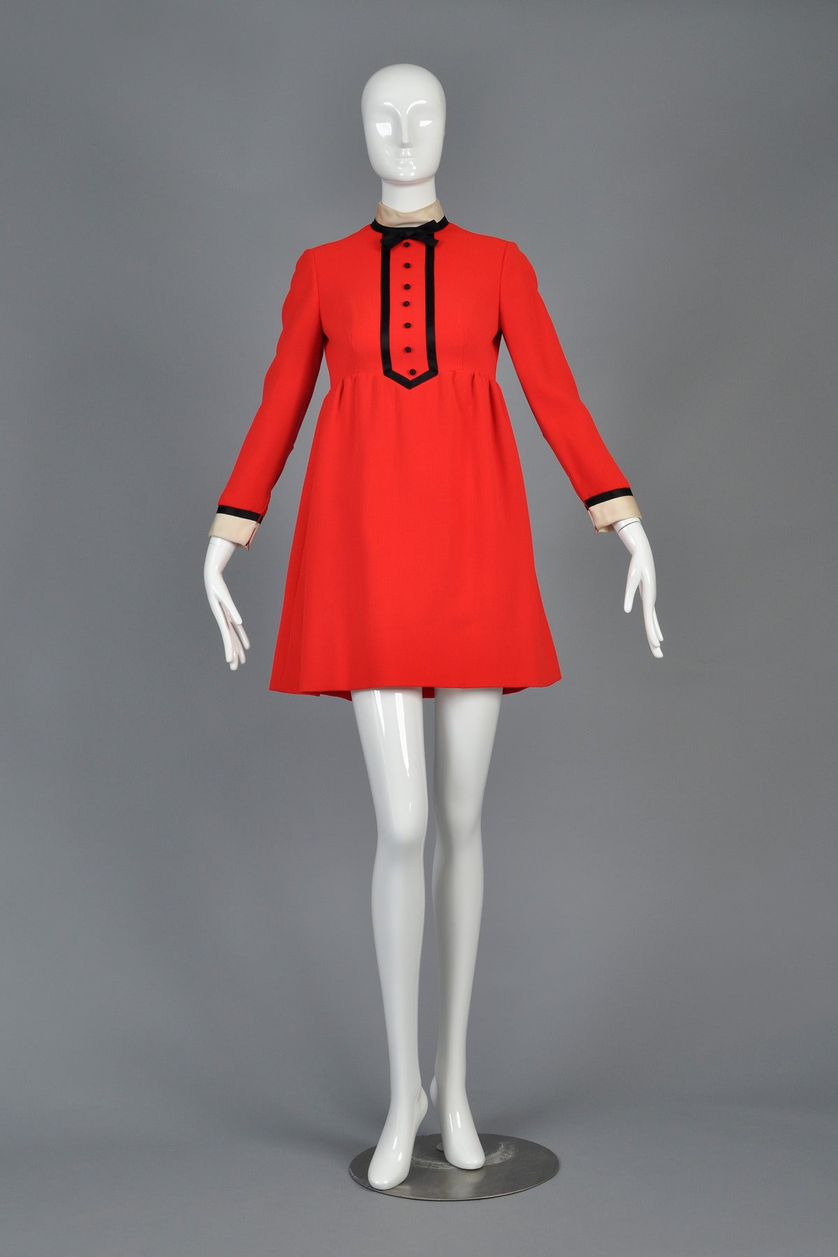 Absolutely adorable circa 1969 Geoffrey Beene red wool mini dress. The ultimate mod piece and perfect for all of your holiday parties! Ultra fitted bodice with classic super-high (almost empire) waistline. High white satin mock-neck and black ribbon