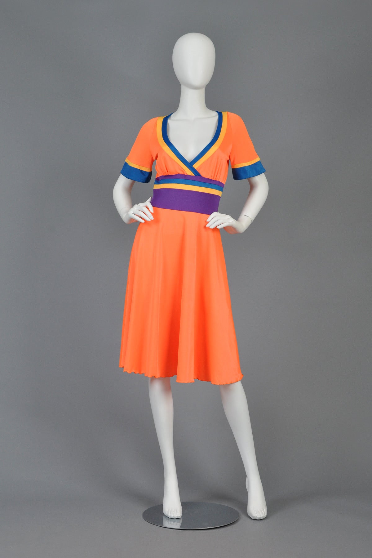 Fabulous 1970s Giorgio Sant'Angelo colorblocked dress. Amazingly bright + fun color palette with plunging, crossover neckline, striped + nipped waist and slightly belled sleeves. Stretchy synthetic. Slips over the head. Excellent vintage condition.