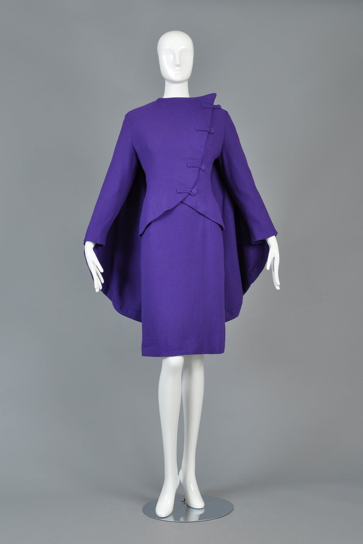 Seriously amazing 1950s eggplant colored wool jacket + dress ensemble. Killer, one-of-a-kind, hand-tailored piece.  Made from mid-weight backed wool, or possibly wool-blend. Simple high-necked dress with 3/4 length sleeves and metal zipper in back.
