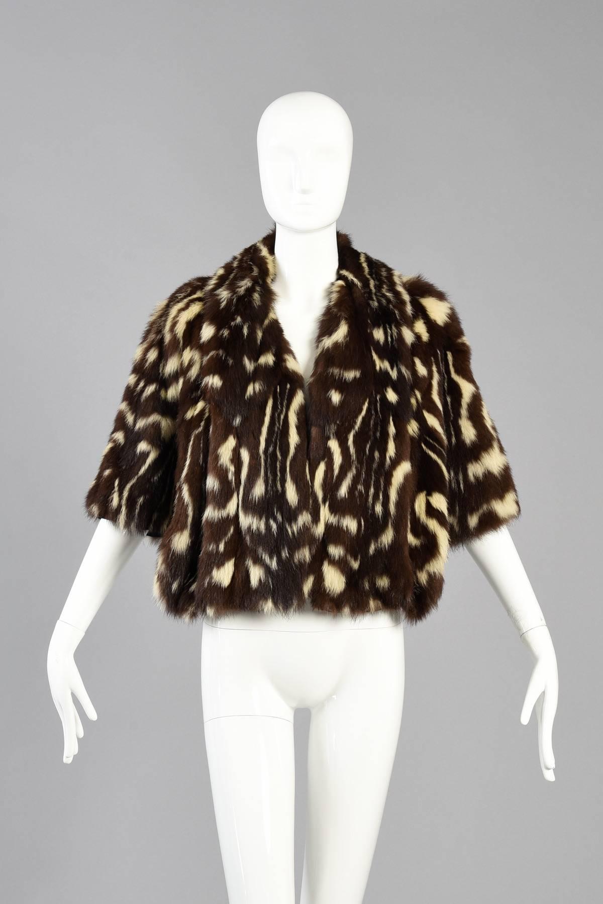 Lovely 1940s spotted skunk (or civet) fur capelet. We LOVE spotted skunk and it's always such a rare find. We've only every found a few over the years. Perfectly chic elbow length cape with scalloped hem. Folded front collar with a little space to