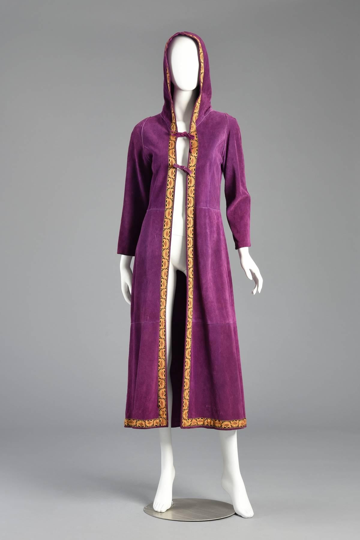 Bohemian dream coat! Phenomenal vintage 1960s purple suede leather hooded jacket. Such a rare and unique color. Soft and supple purple suede with gold tapestry trim. Sleek fit with hood and double tie-front closures. Freshly cleaned + conditioned.