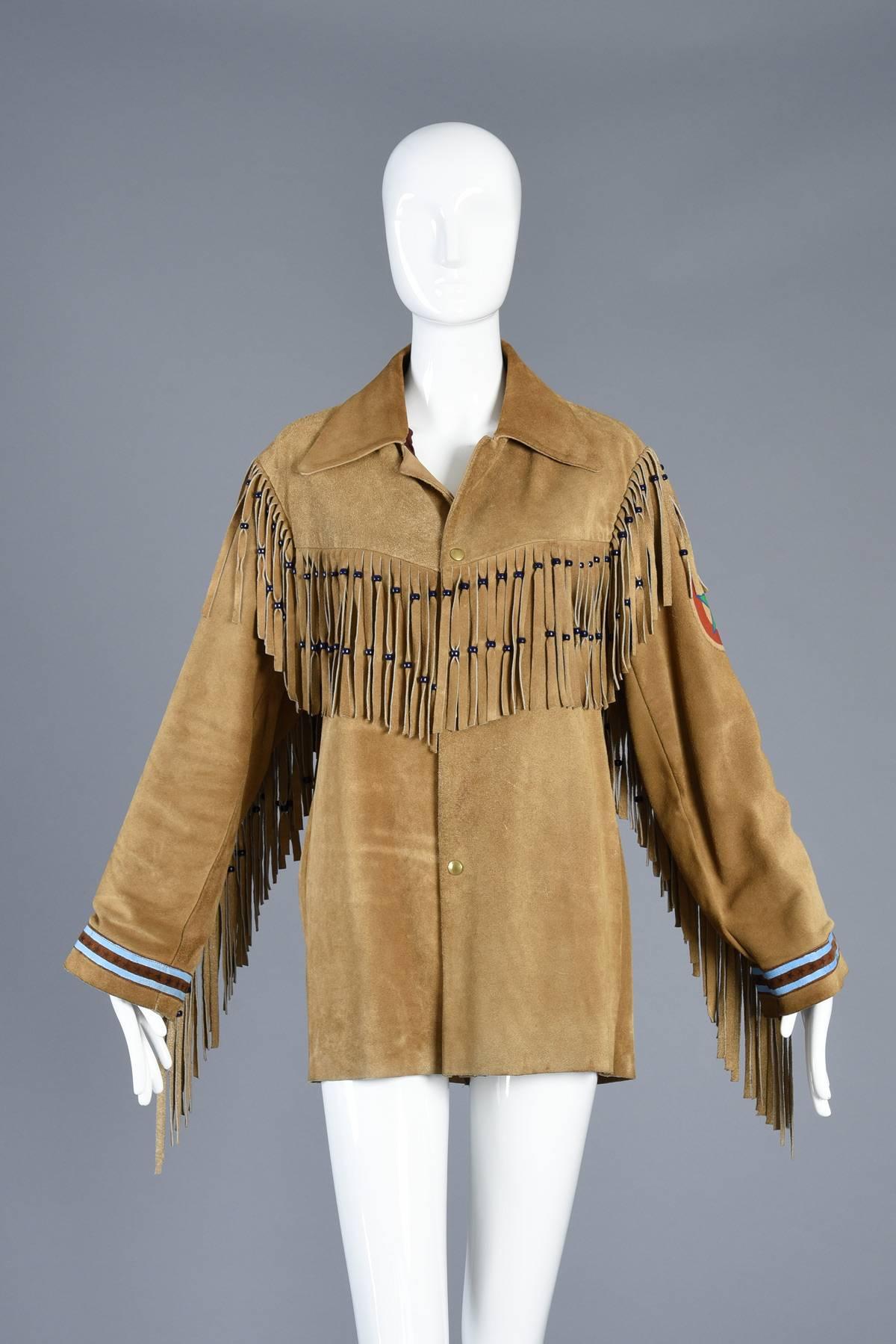 Hands down one of the coolest coats we’ve ever had. Phenomenal vintage 1960s suede jacket with super long beaded fringe across chest, back + down the arms. Hand painted stars + stripes appliqués on sleeve cuffs, bullseye + star appliqué on arm + a