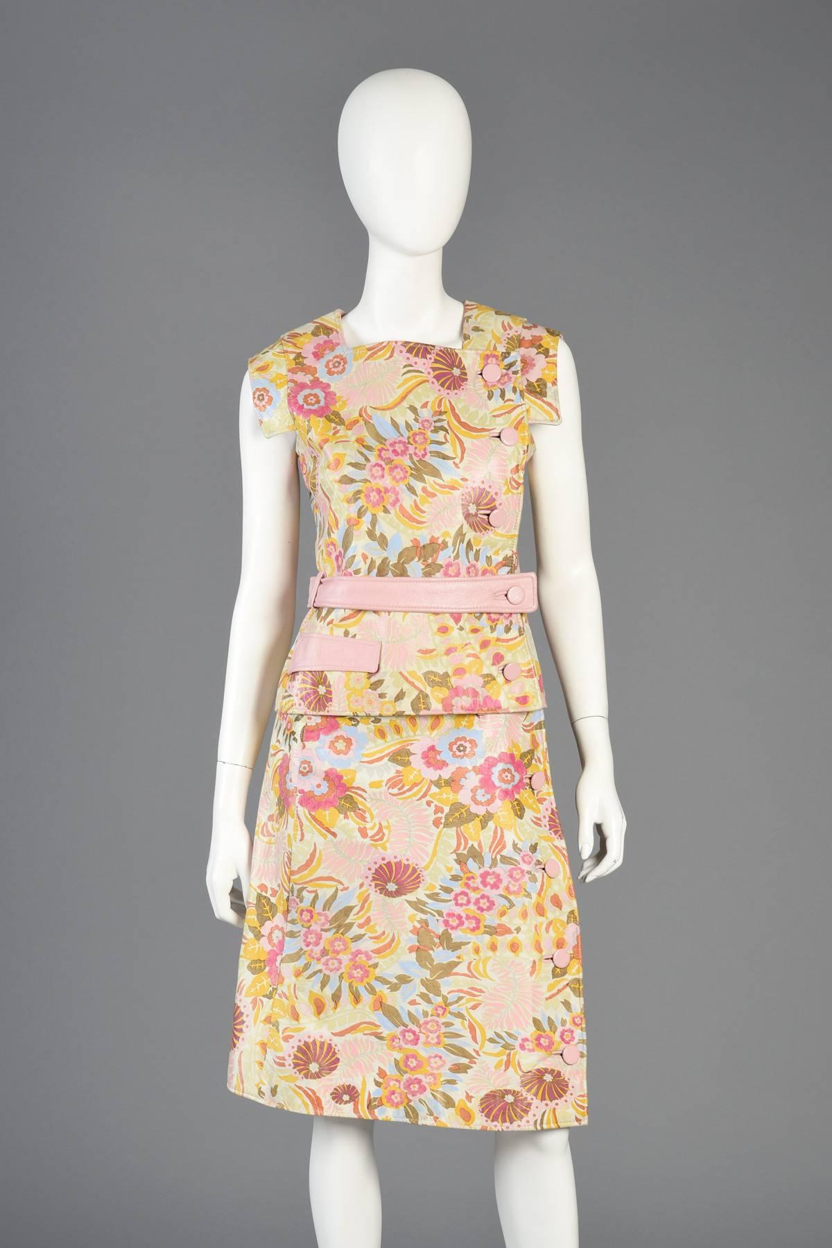 Incredible vintage 1960s 3-piece hand-painted floral leather ensemble by Samuel Robert. Pale ivory leather with hand-painted rainbow florals. Space age meets avant garde top features asymmetric button closure, winged shoulders, angled pocket + belt.