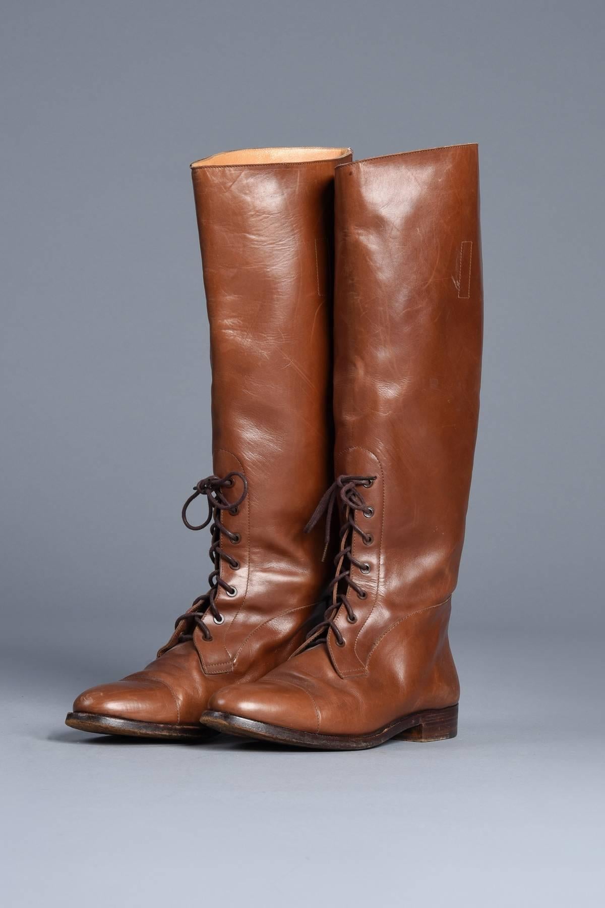 Absolutely beautiful Ralph Lauren leather equestrian boots. Gorgeous cognac leather with lace up front. All leather inside and leather soles. Also includes the original cotton evergreen dust bags with leather tassel drawstring closure. 

Marked US